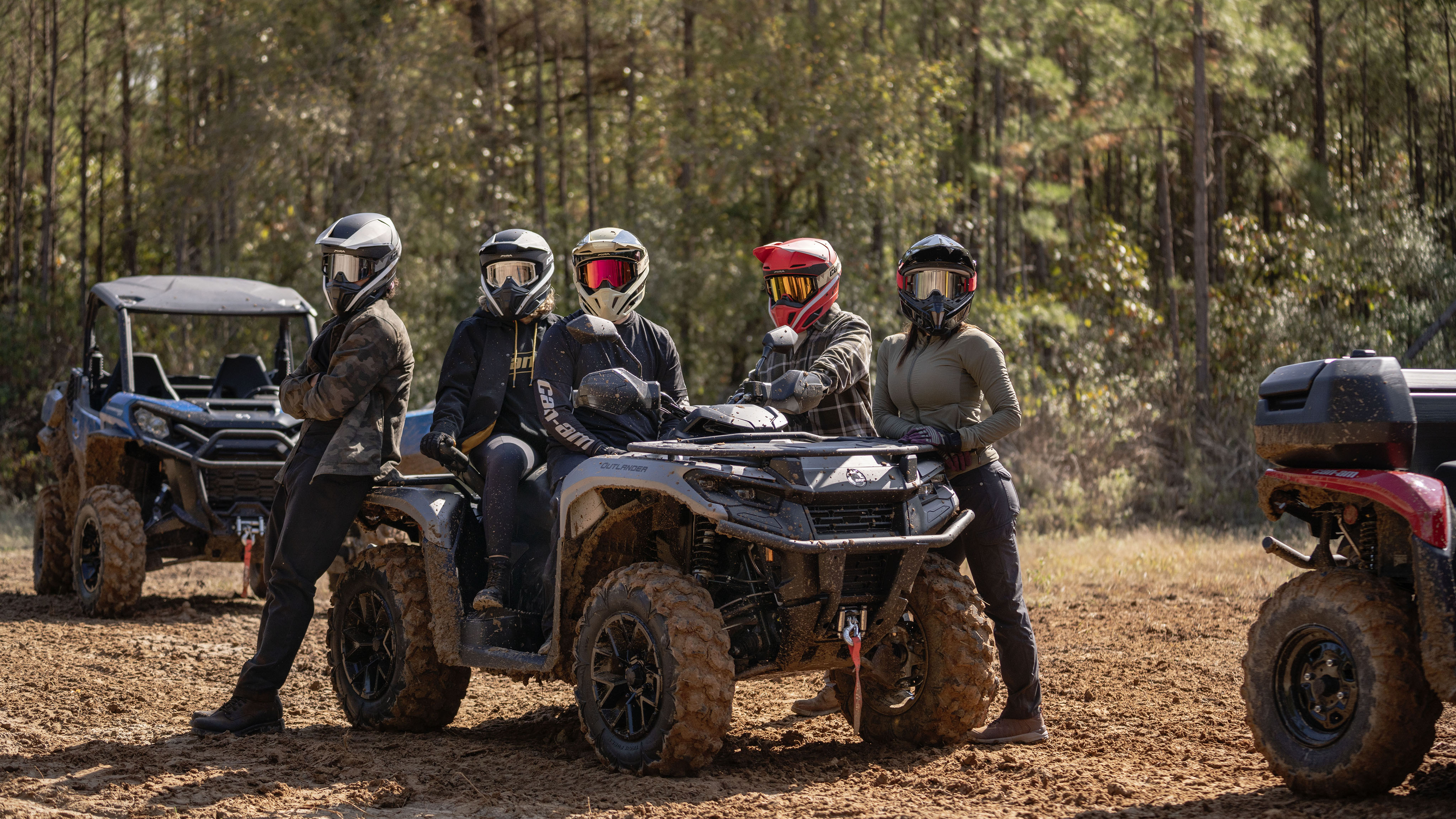 A group of Friends around an Outlander 500/700 on a group trail ride