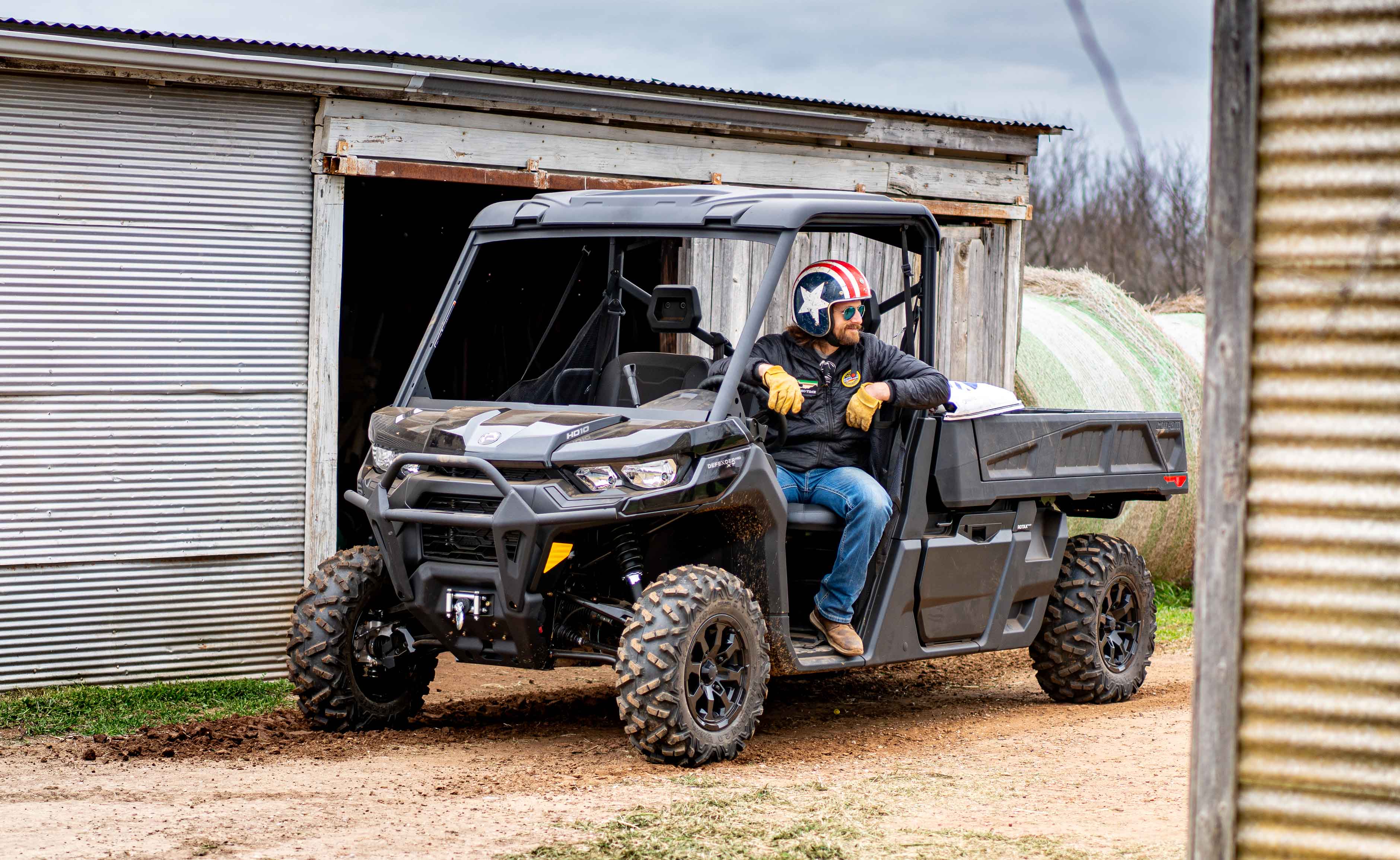 Dale Brisby sitting in a Can-Am Defender PRO side-by-side