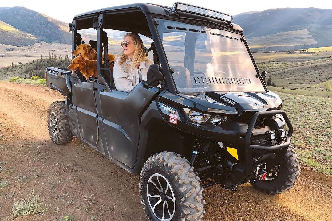 Claire Gierke and her two Red Retrievers in her Can-Am Defender Lone Star MAX SxS