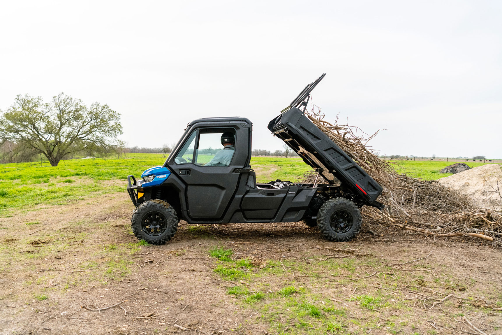 A man unloading woods from a Can-Am Defender Limited side-by-side