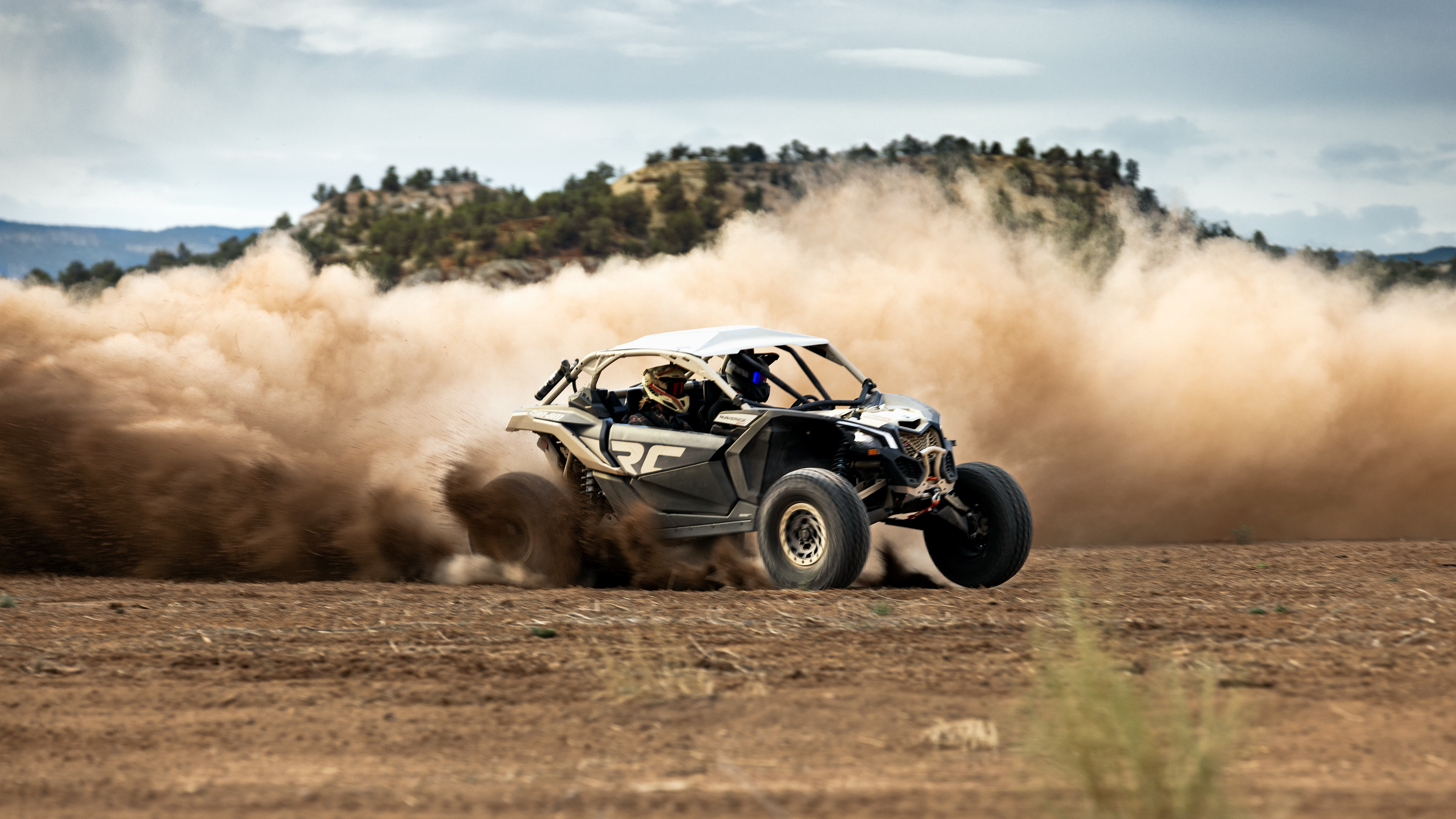 A Mineral Grey and Desert Tan Can-Am Maverick X3 RC 72 Turbo RR kicking up dust