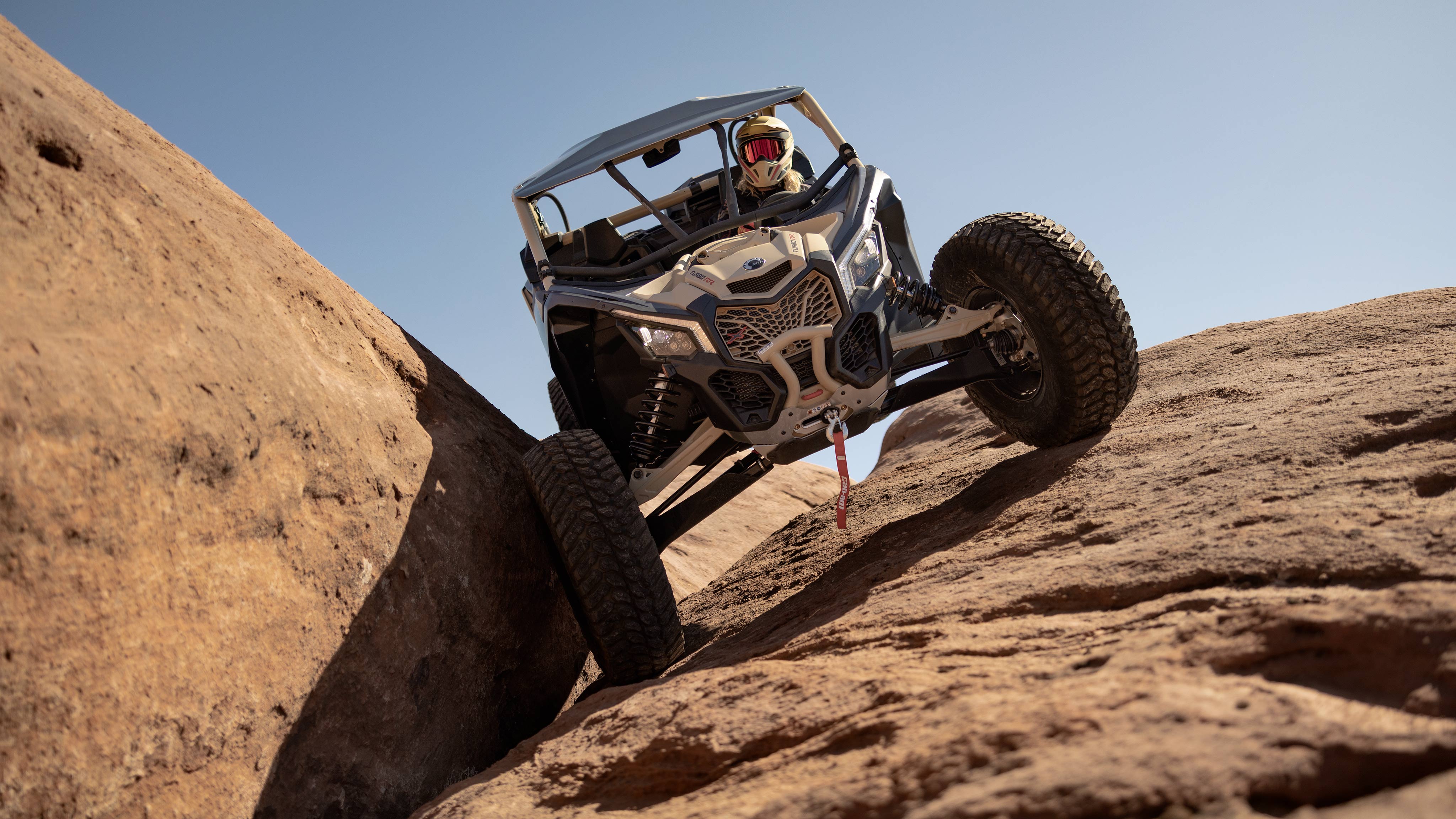 A Mineral Grey and Desert Tan Can-Am Maverick X3 RC 72 Turbo RR on a rock climbing expedition