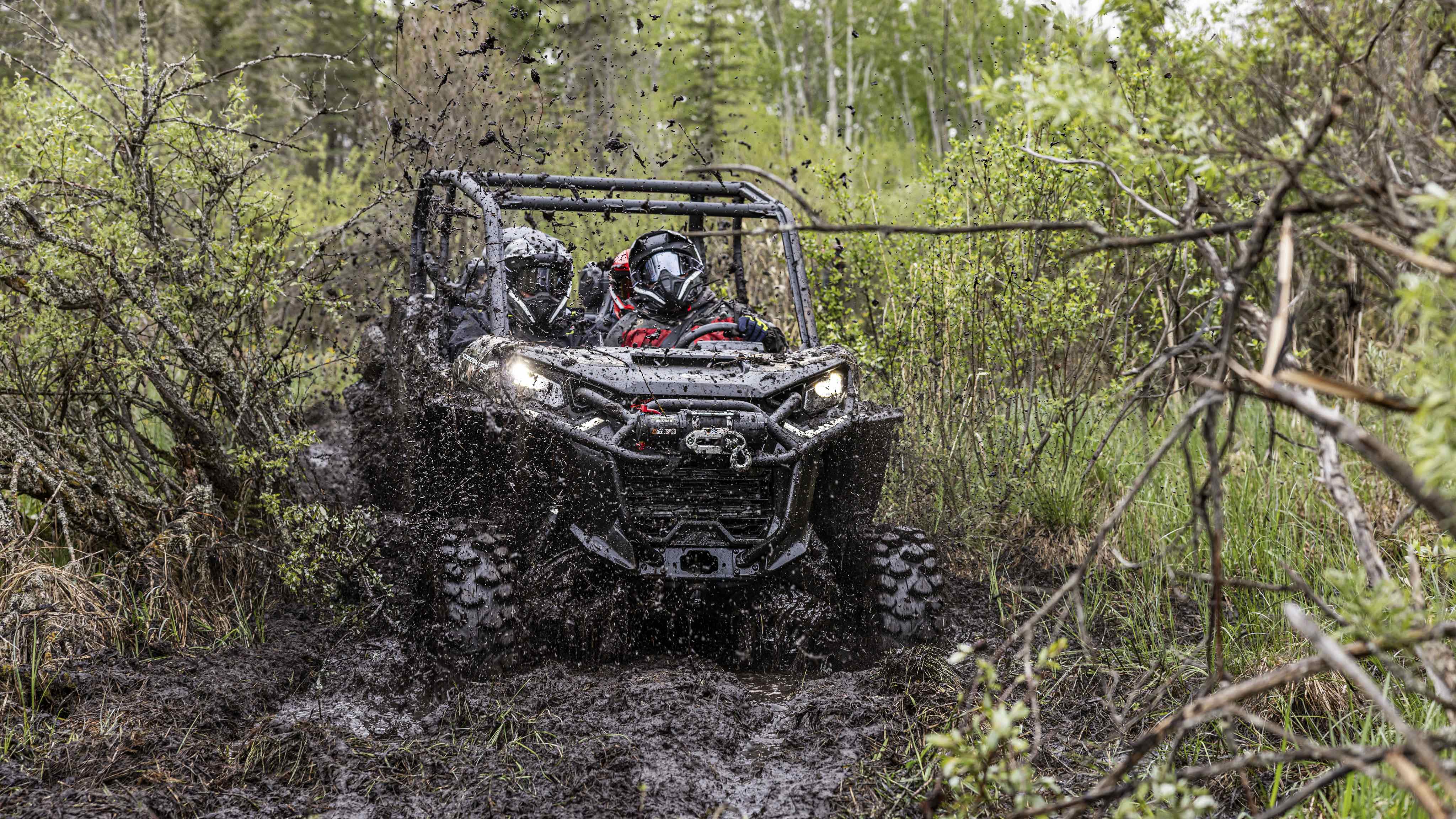 A Can-Am Commander Max X MR traveling in the mud