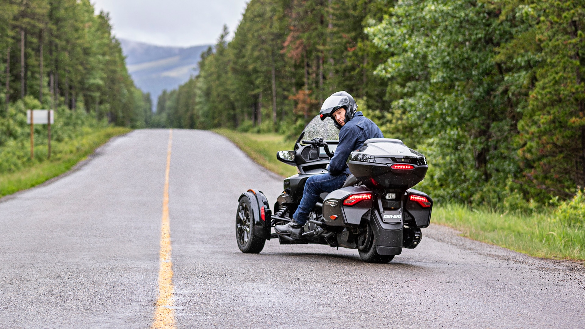 Rider sitting on a Can-Am Spyder 3-Wheel and looking behind