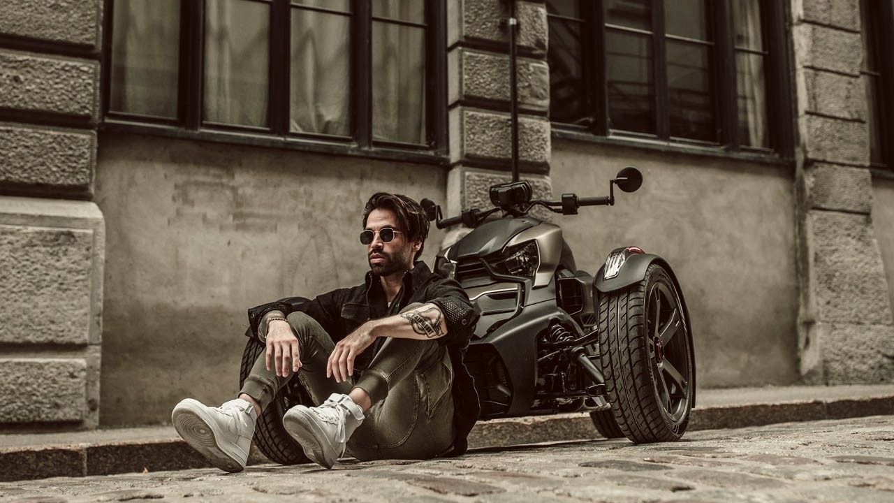 Man sitting in fornt of his Ryker. 