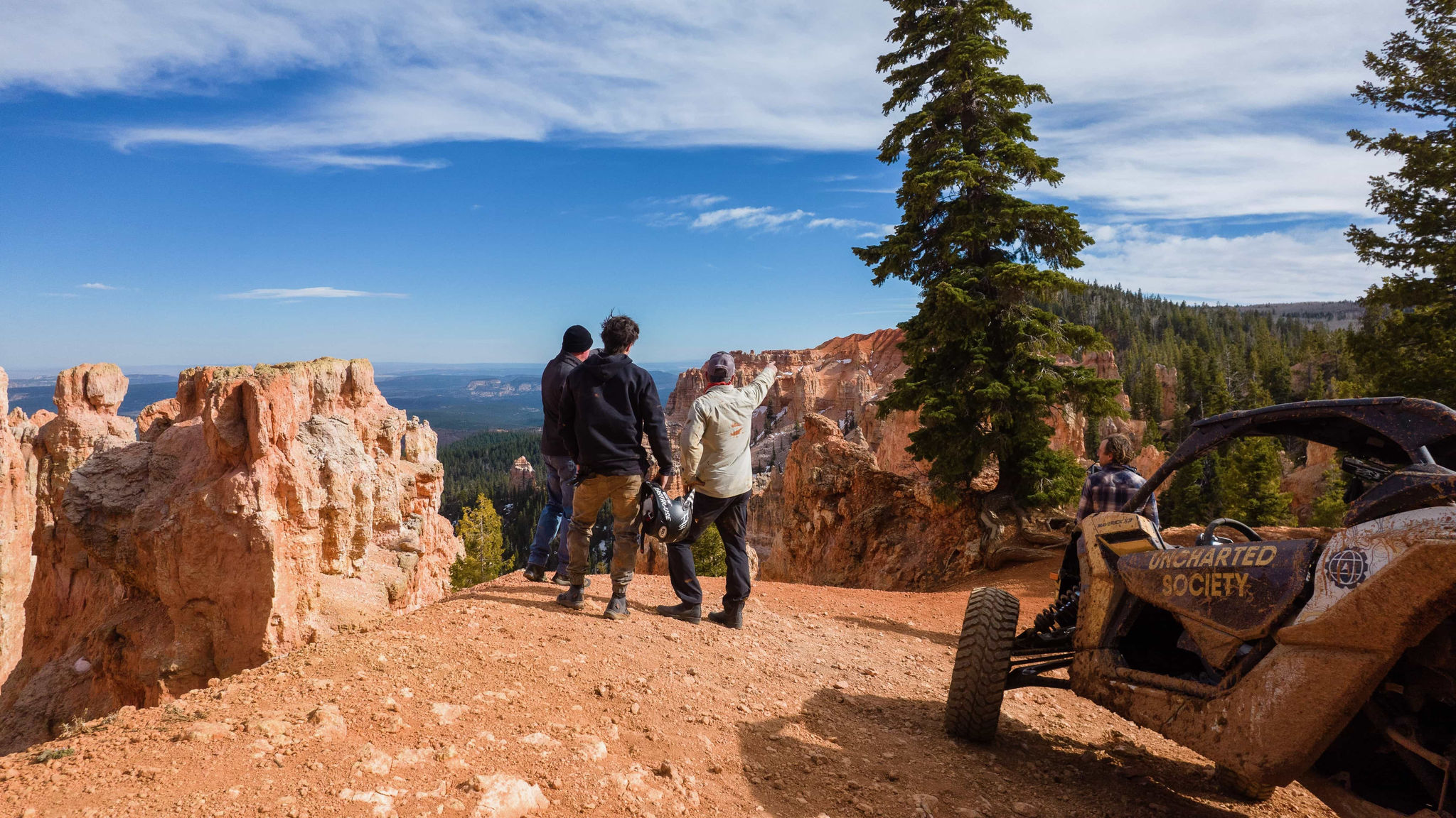 A group of people on the edge of a cliff looking out