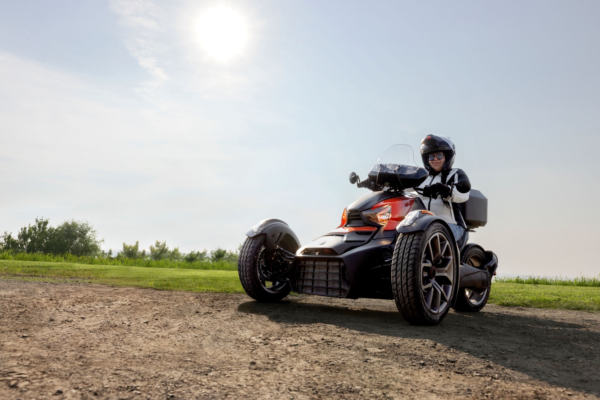 A Can-Am female rider sitting on a 2026 Ryker