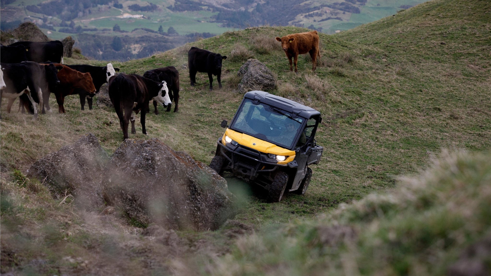 Can-Am Defender driving through a field