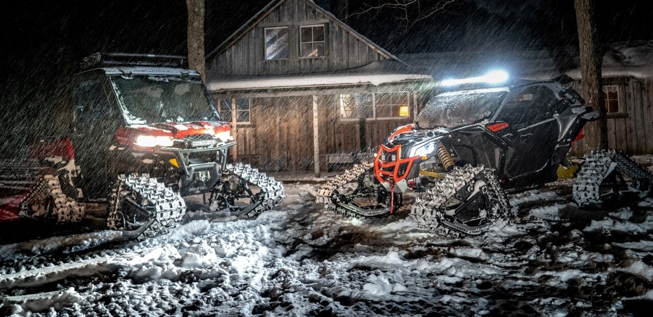 Two Can-Am SxS vehicles equipped with Apache track system