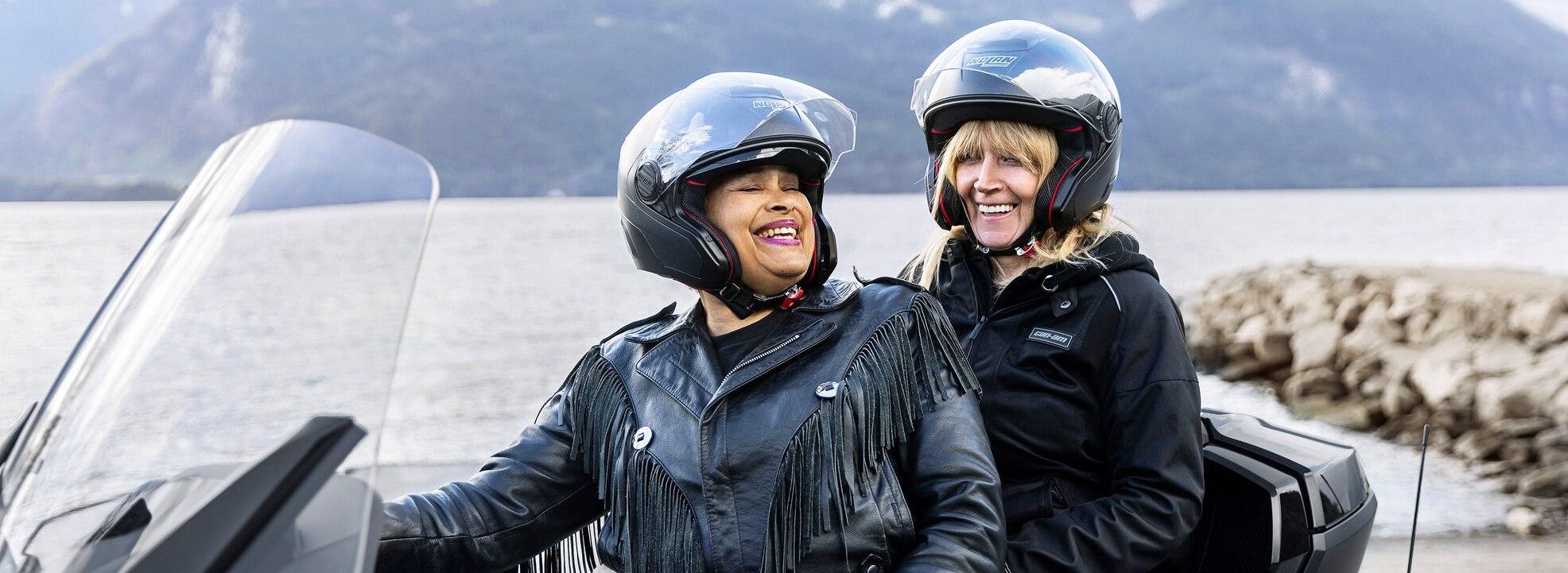 Two female drivers smiling on a Can-Am Spyder RT