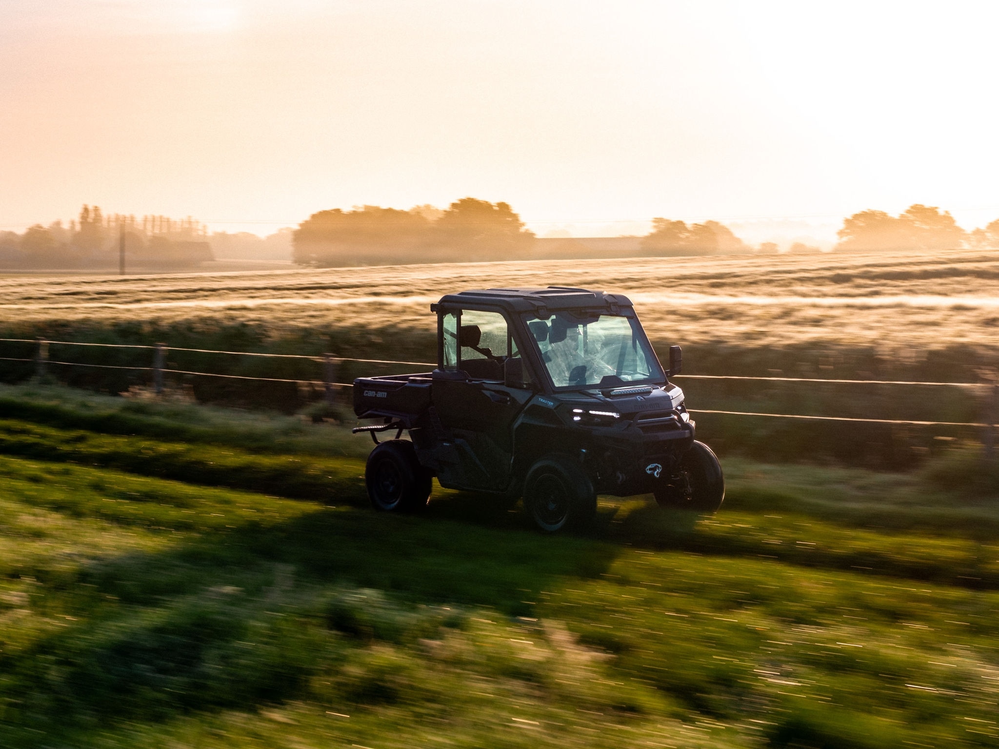 A Can-Am Traxter XU HD11 riding at high speed in a field