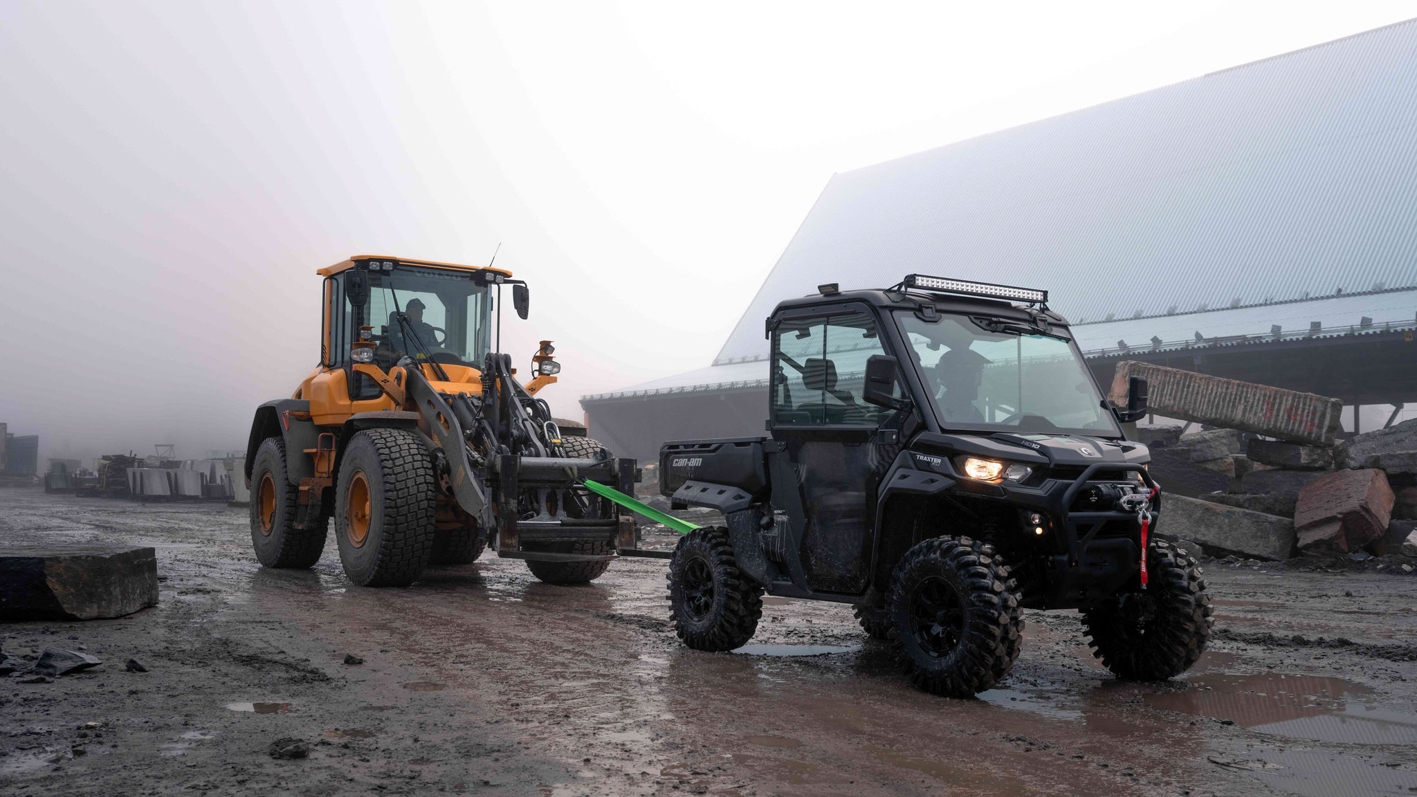 Can-Am Traxter pulling a Tractor. 