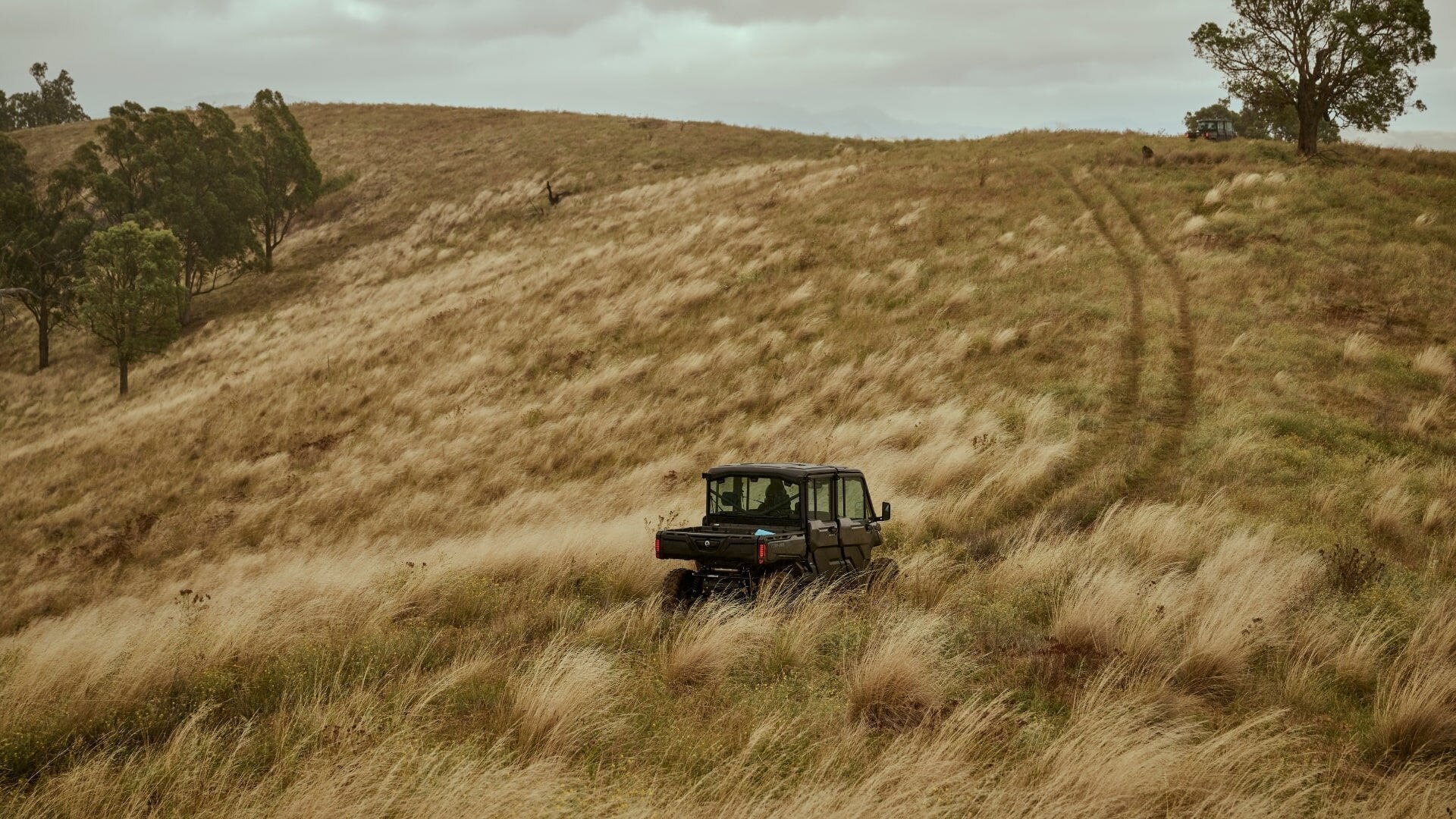 Can-Am Defender driving through a field