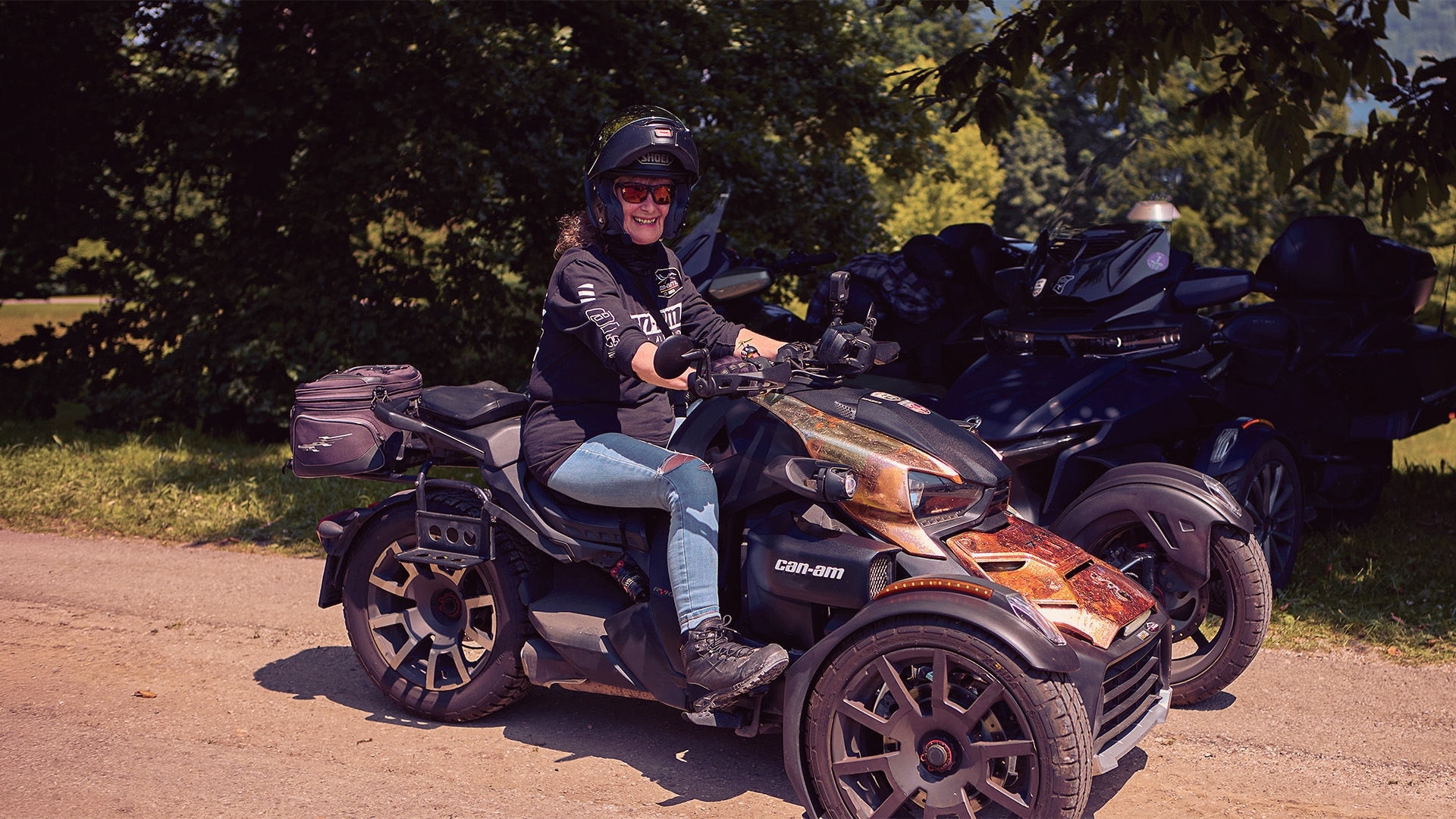 A woman sitting on her custom Can-Am three-wheeler