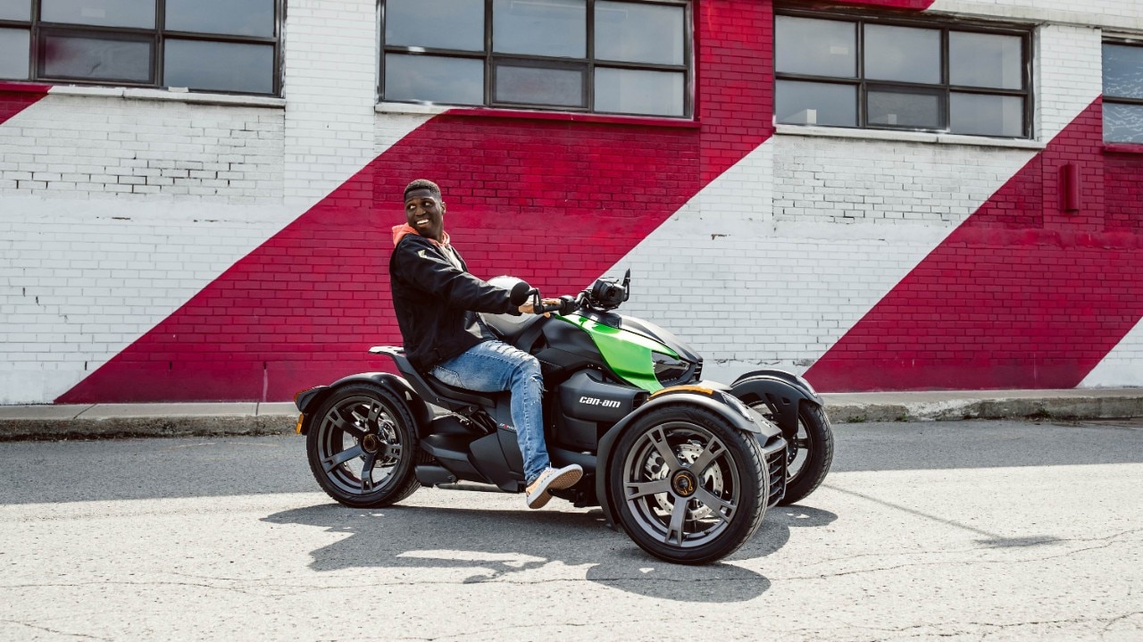 Man sitting and smiling on his Can-Am Ryker