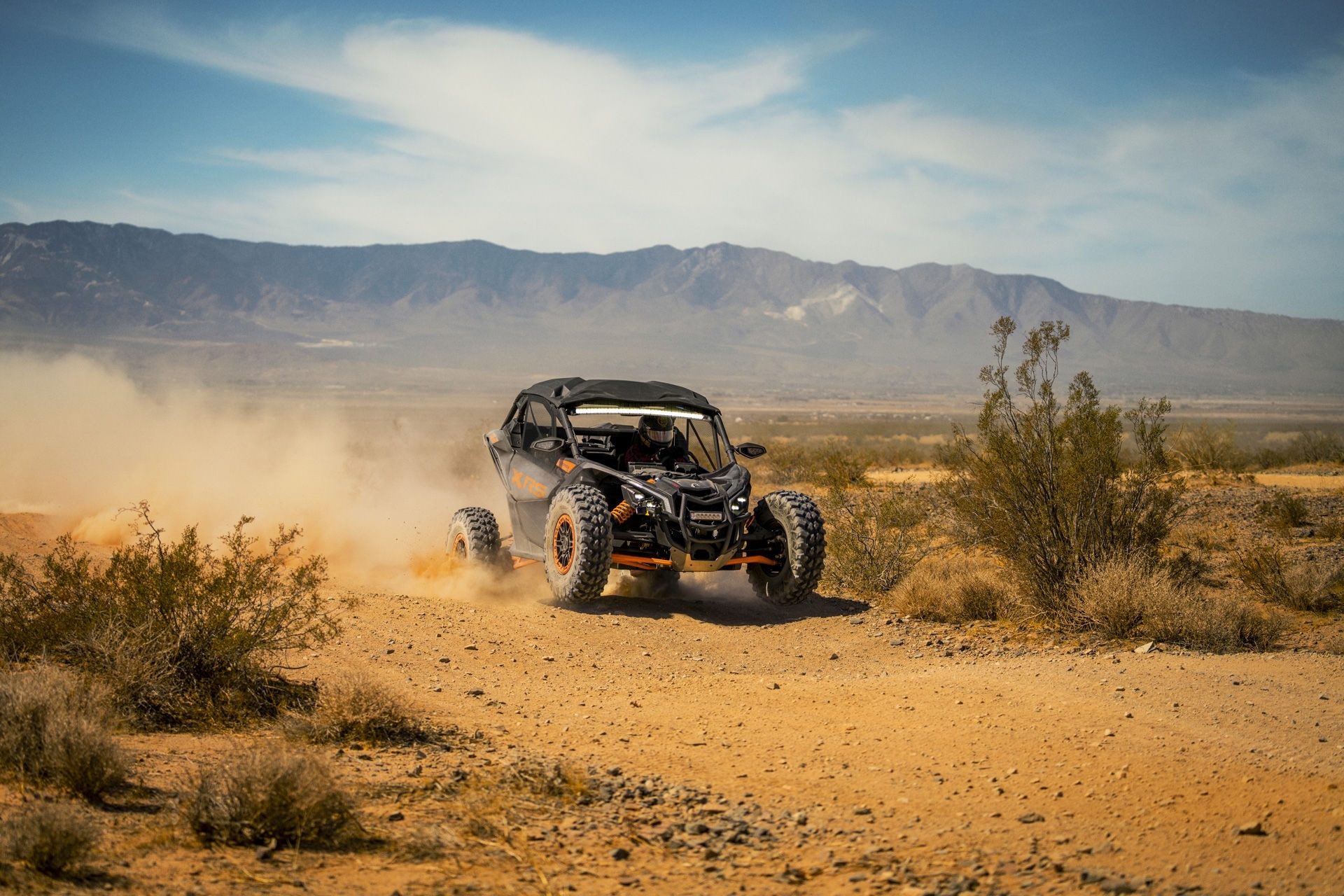 Can-Am Maverick SxS riding atop a hill in the desert