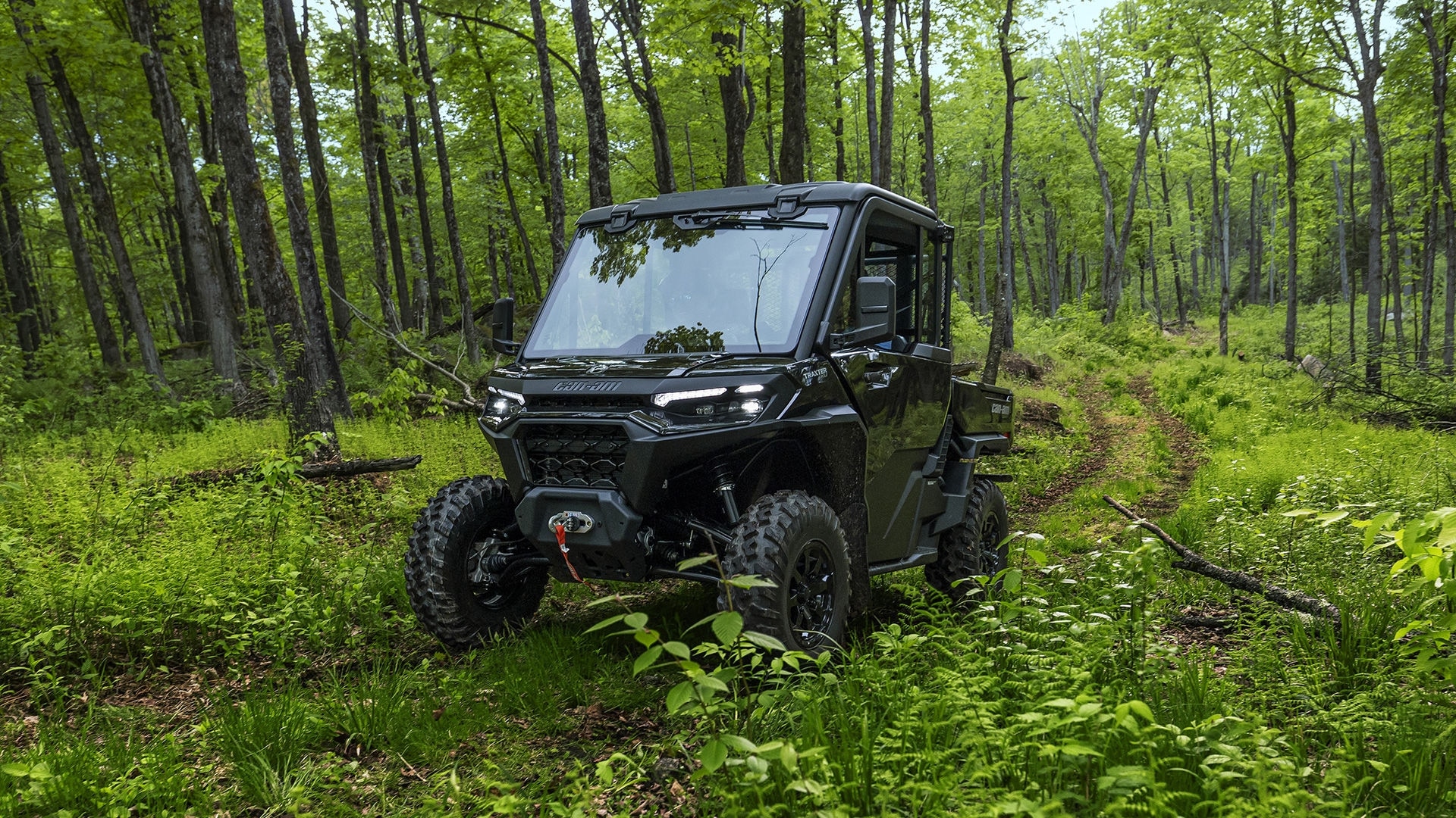 2026 Can-Am Traxter HD11 driving in a forest