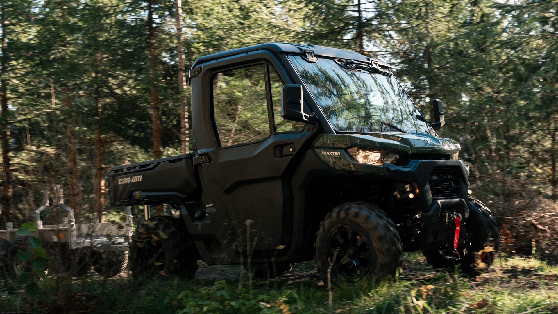 2026 Can-Am Traxter driving in a forest