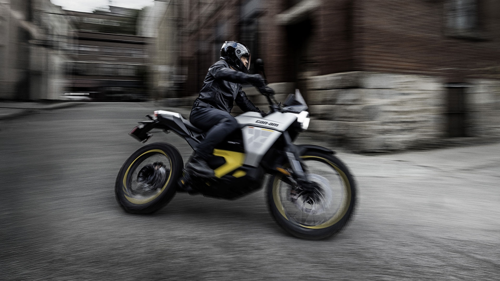 2026 Can-Am Origin electric motorcycle driving fast in a city