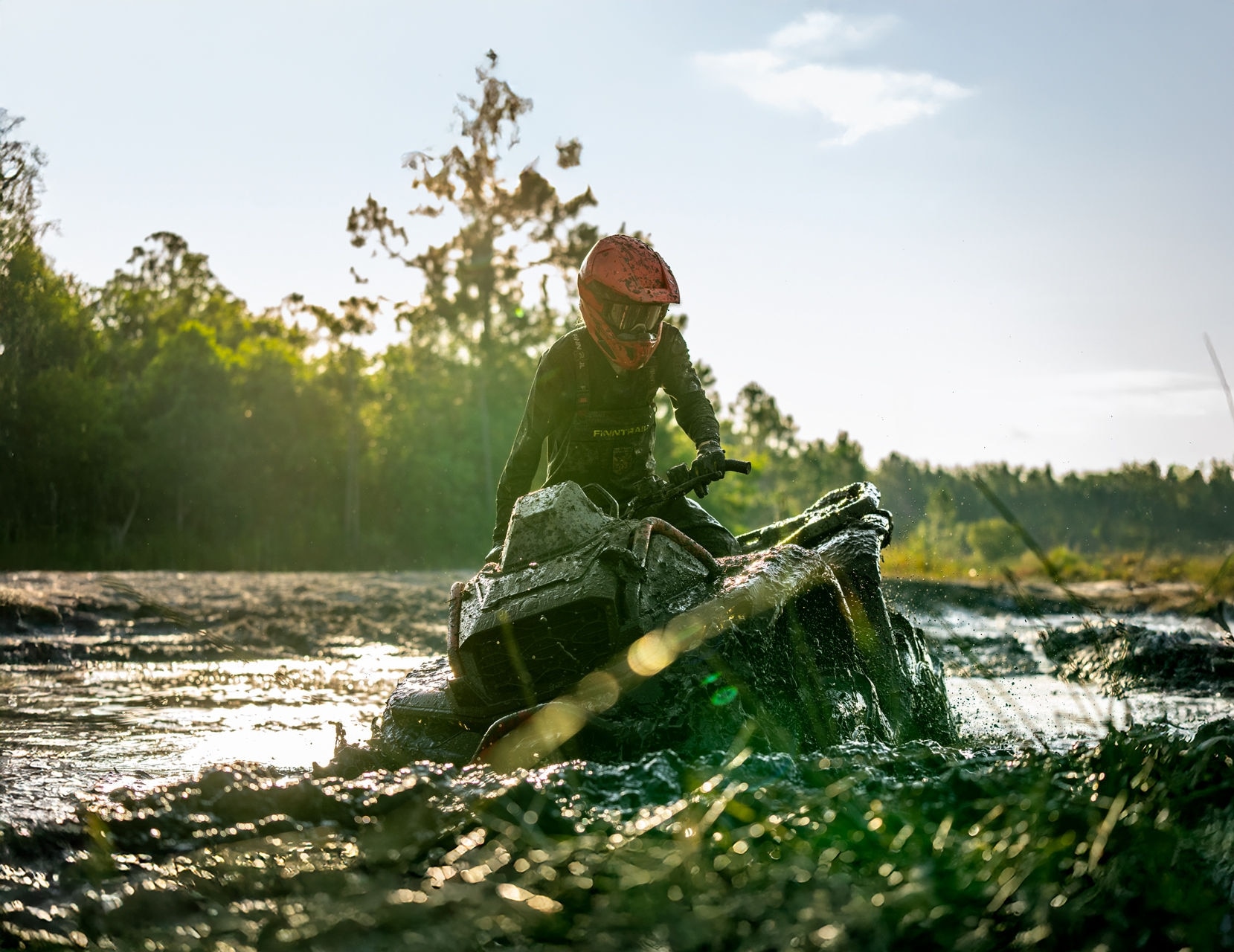 A rider driving in the mud with his new 2025 Can-Am Outlander X MR 1000R