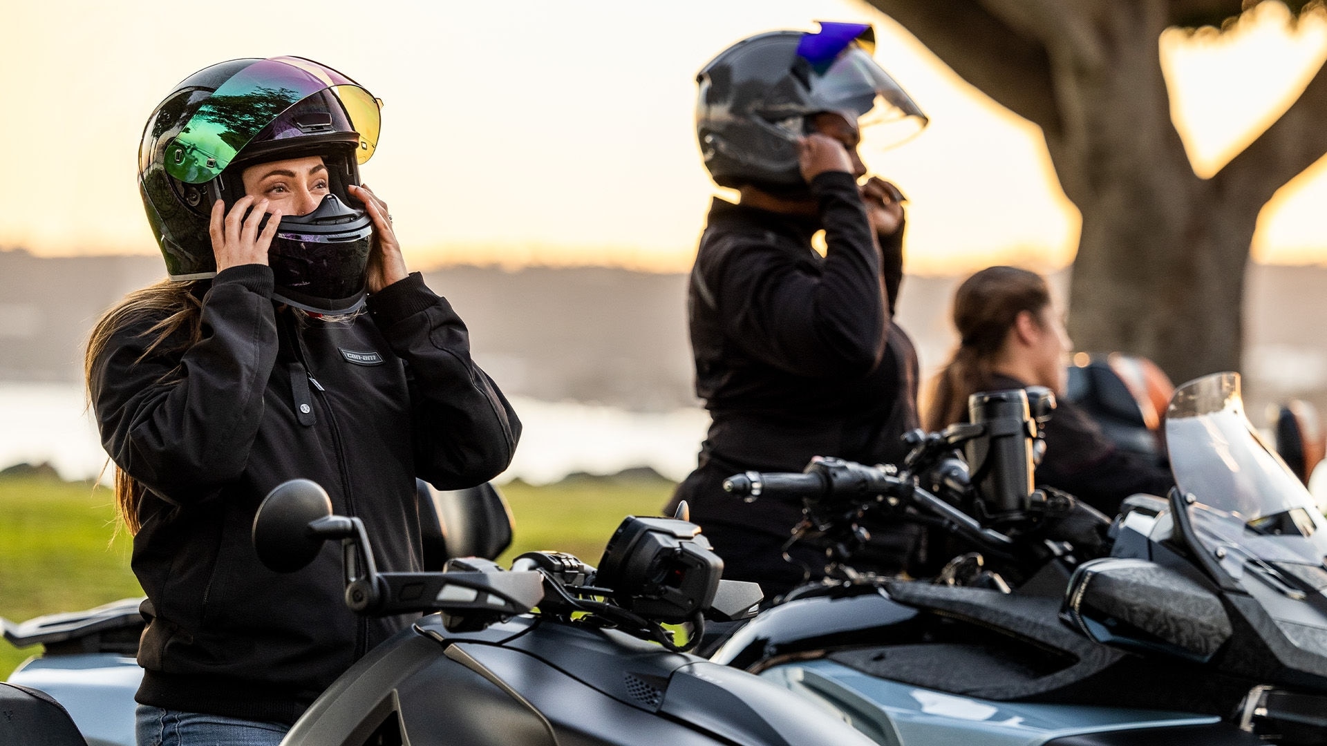 Several female drivers wearing Can-Am gear sit on their 3-wheeled Can-Am vehicles