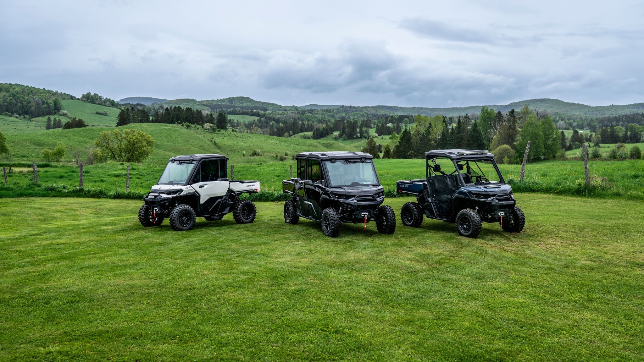 Three 2026 Can-Am Defenders parked in a paddock