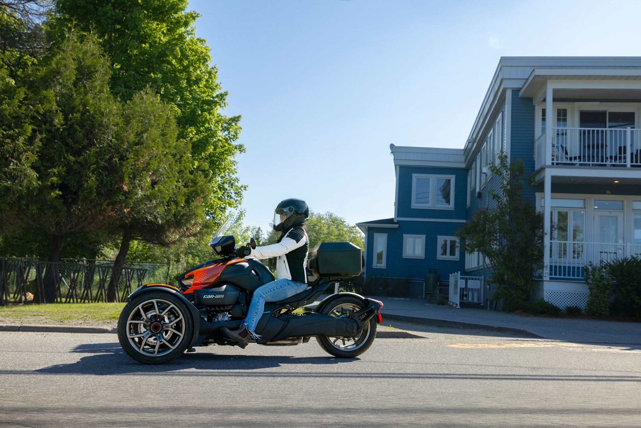 A female rider riding a 2026 Can-Am Ryker on the street