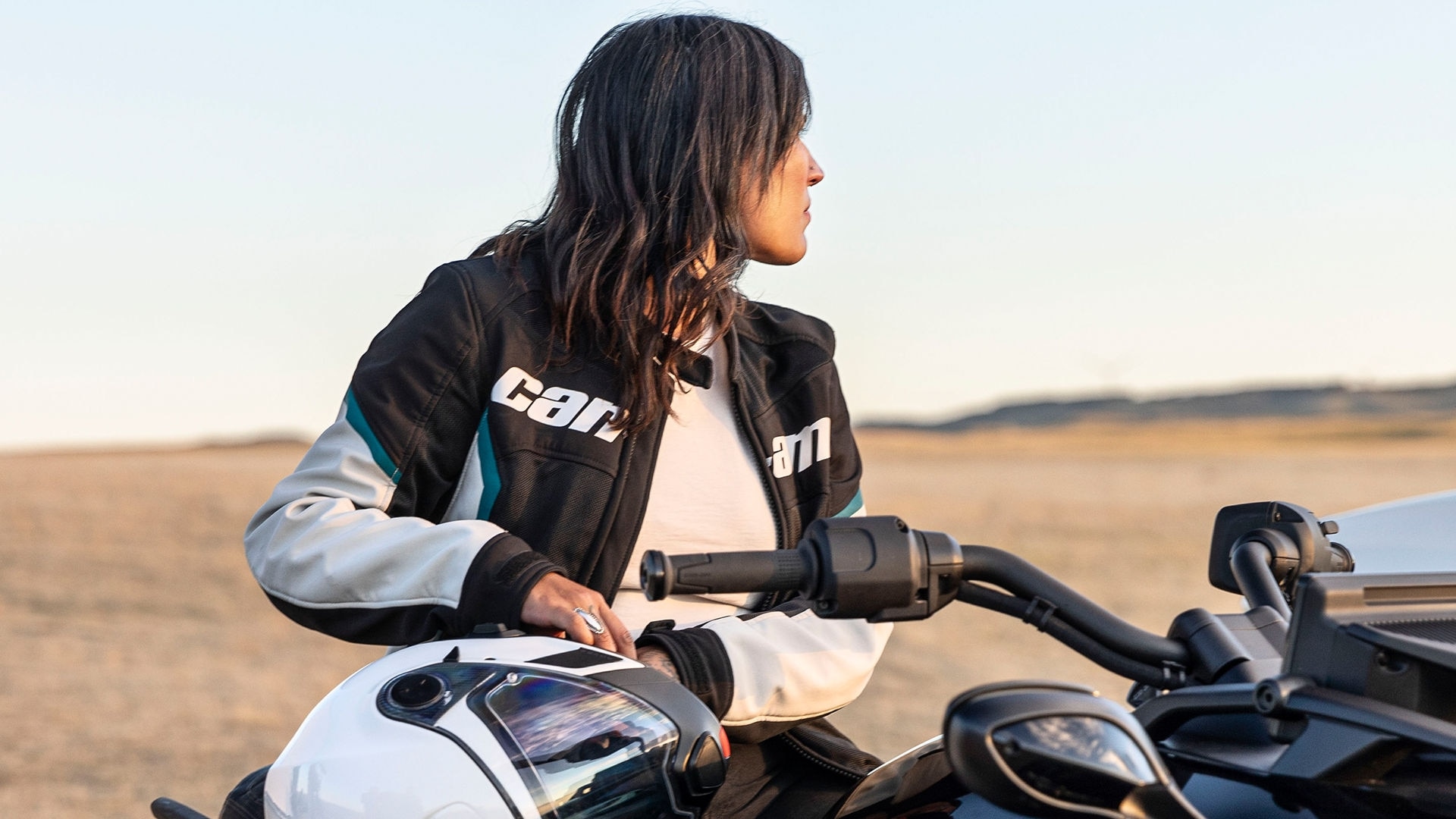 Women sitting on a Can-Am 3-Wheel vehicle with Can-Am Apparel