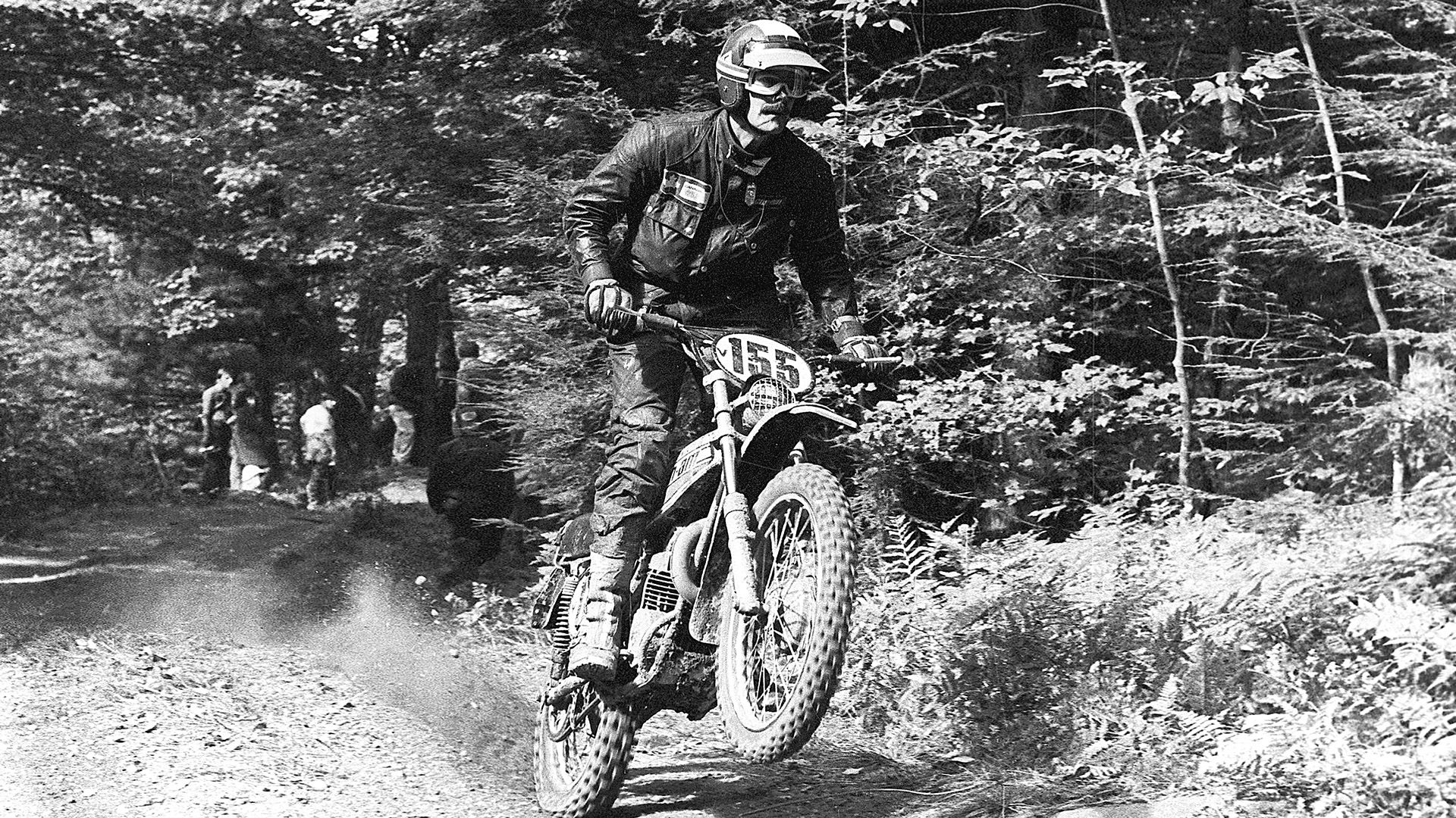 Man riding his Can-Am motorcycle on a dirt road