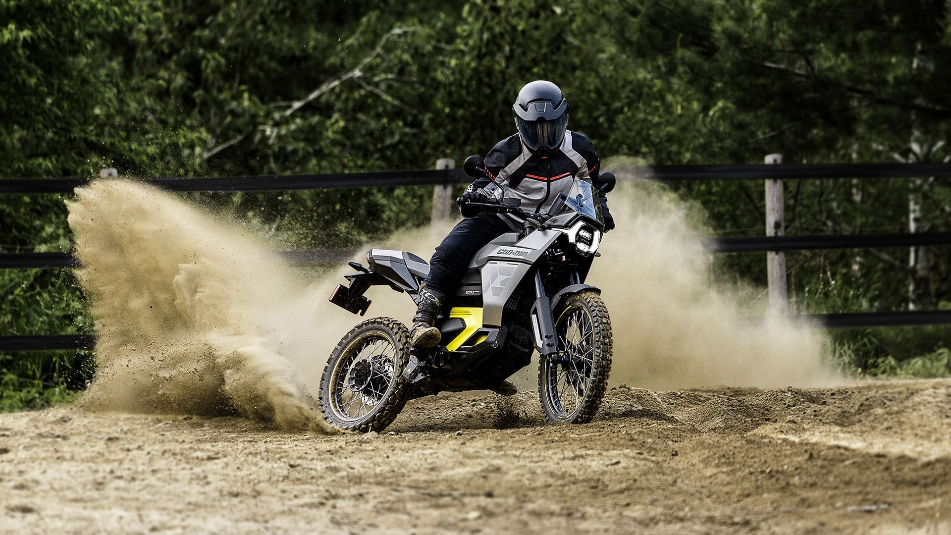 A motorcyclist riding a Can-Am Pulse electric motorcycle on the dirt