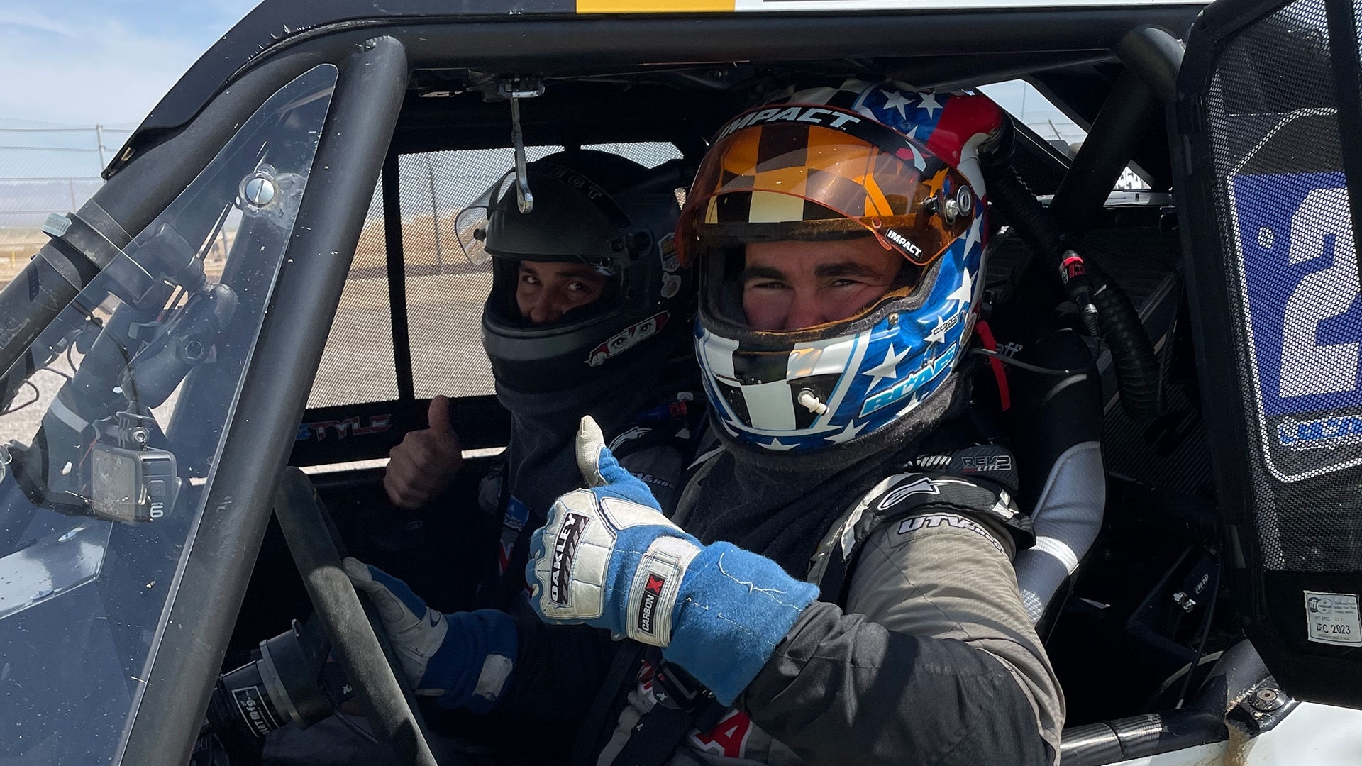 Chris Blais and a friend aboard his Can-Am Maverick giving the thumbs up