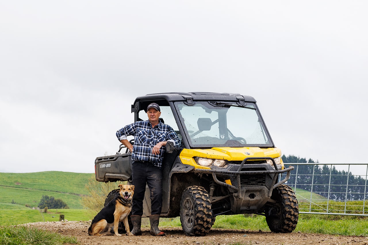 Sir David Fagan standing next to a Can-Am Defender