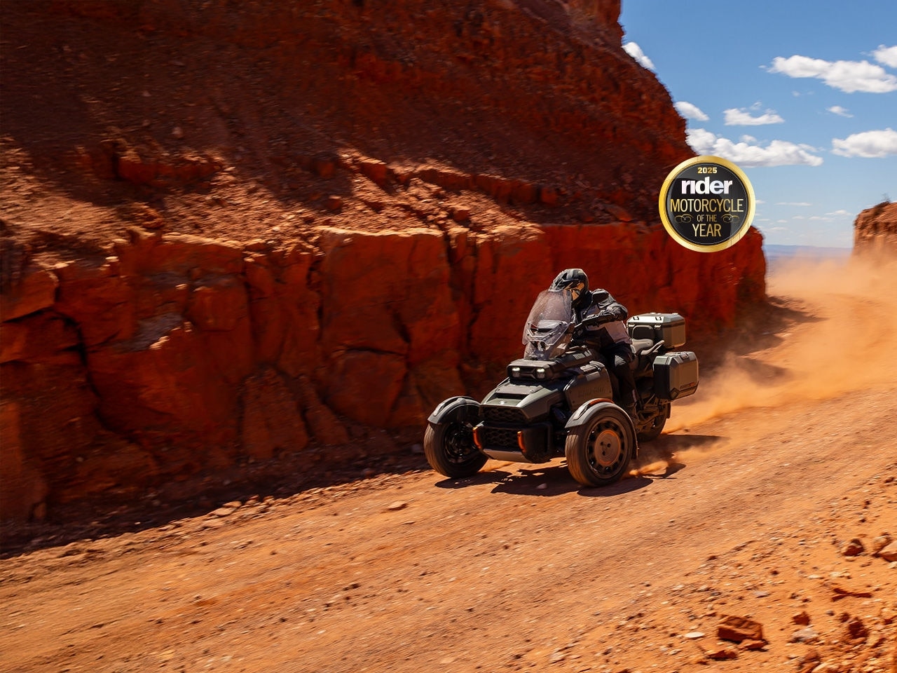 A driver testing a 2025 Can-Am Canyon on a dirt road