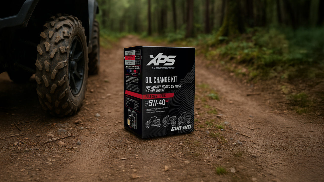 XPS Oil Change Kit on dirt path next to Can-Am vehicle tire 