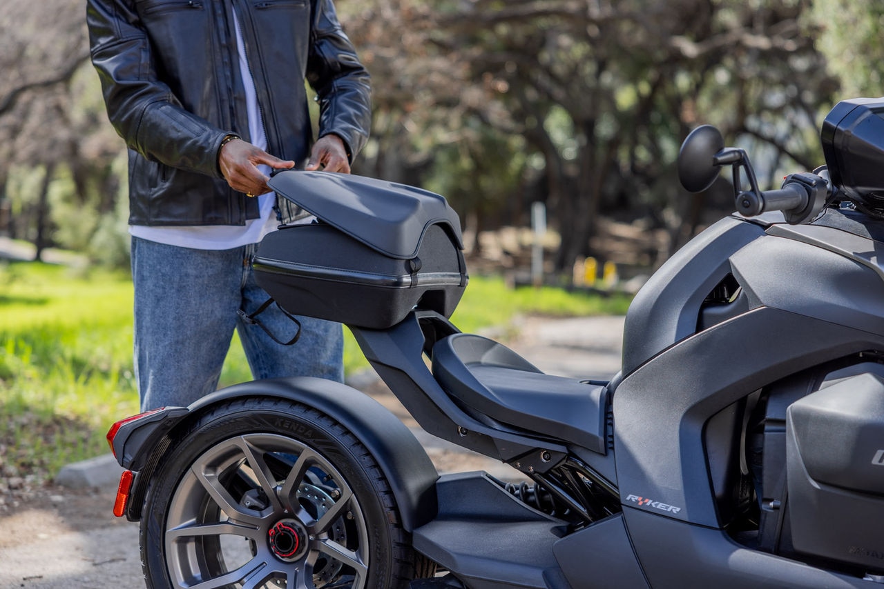 Driver opening its LinQ storage on a Can-Am Ryker Rally 2023 in a desert