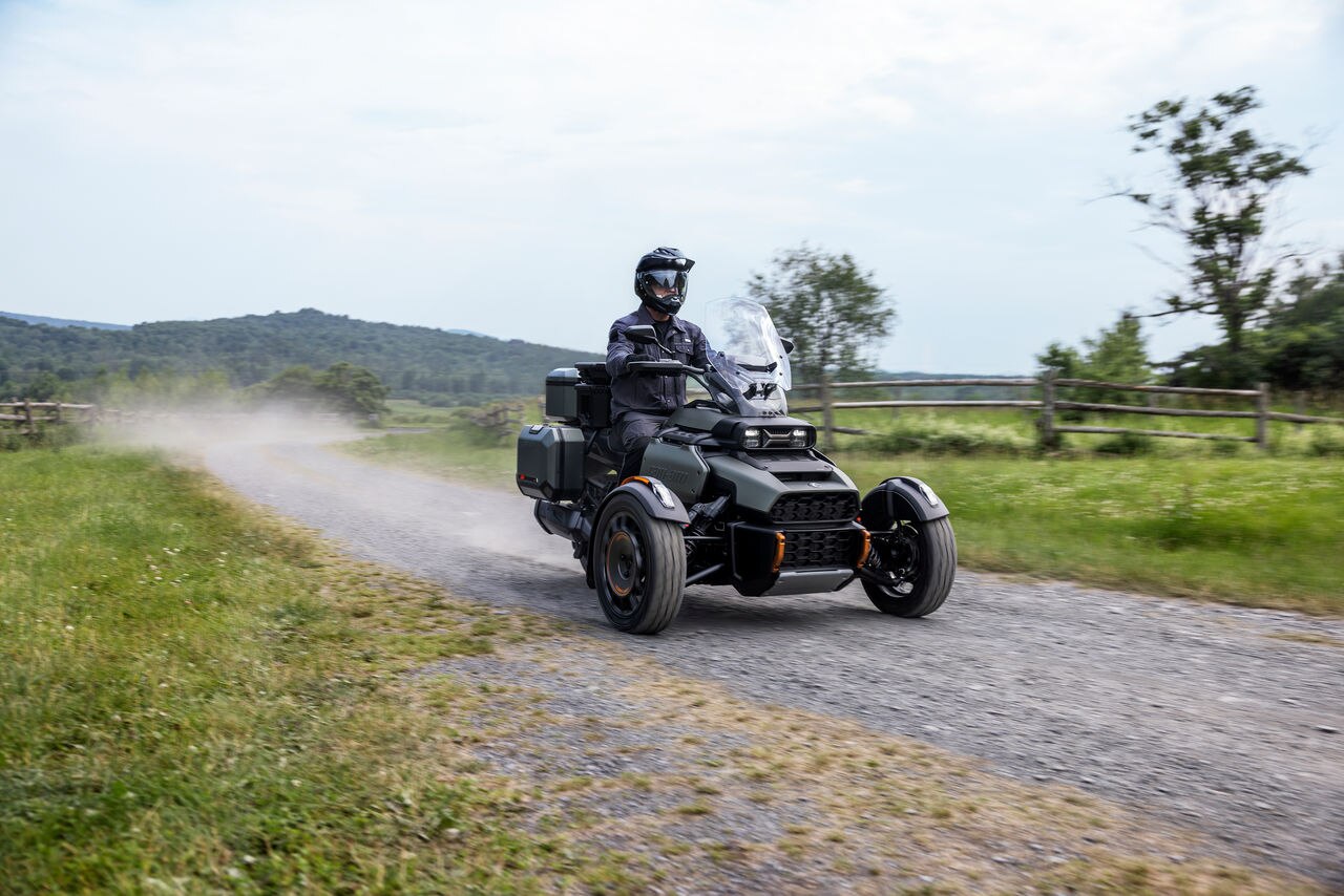 A rider on the all-new Can-Am Canyon motorcycle on an unpaved road