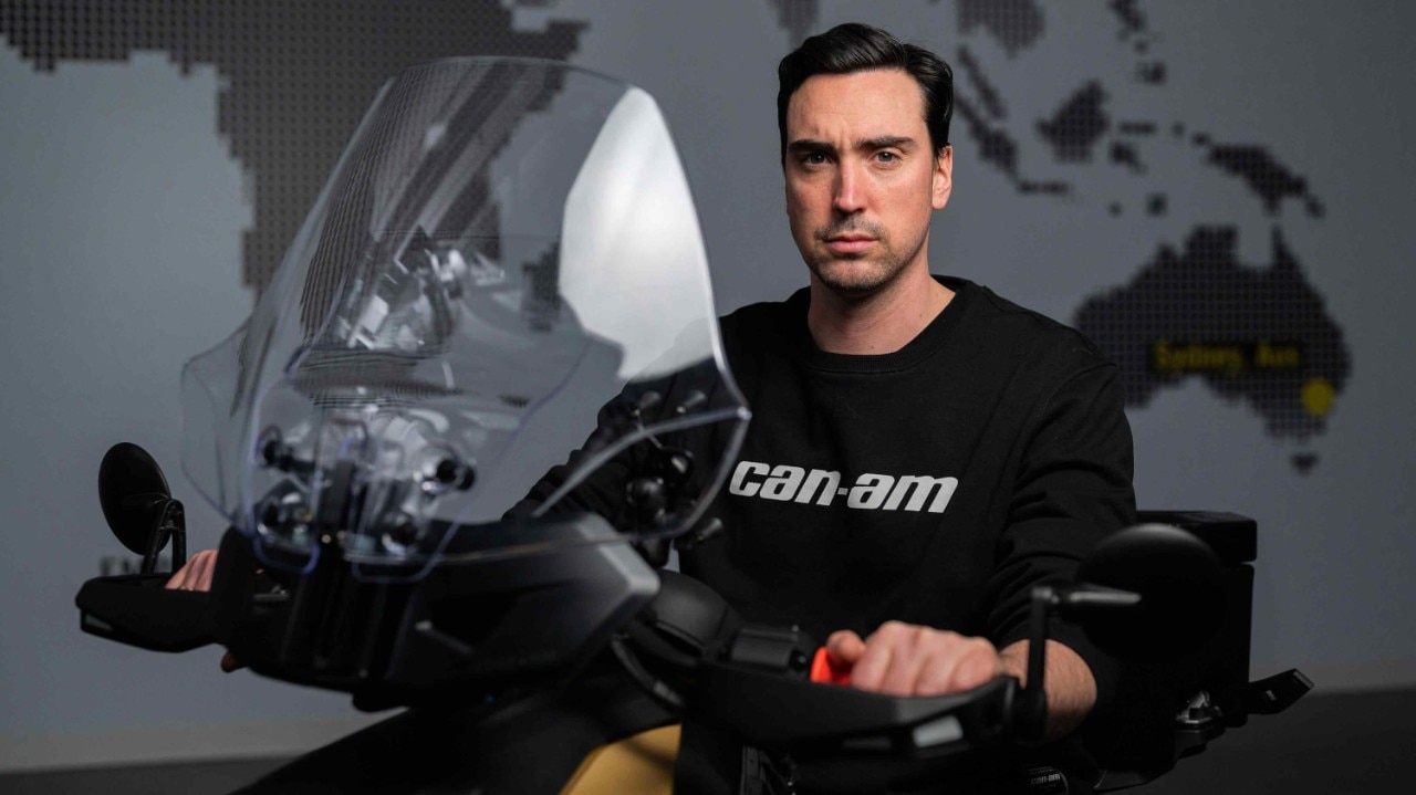 Louis Ménard sitting on parked vehicle