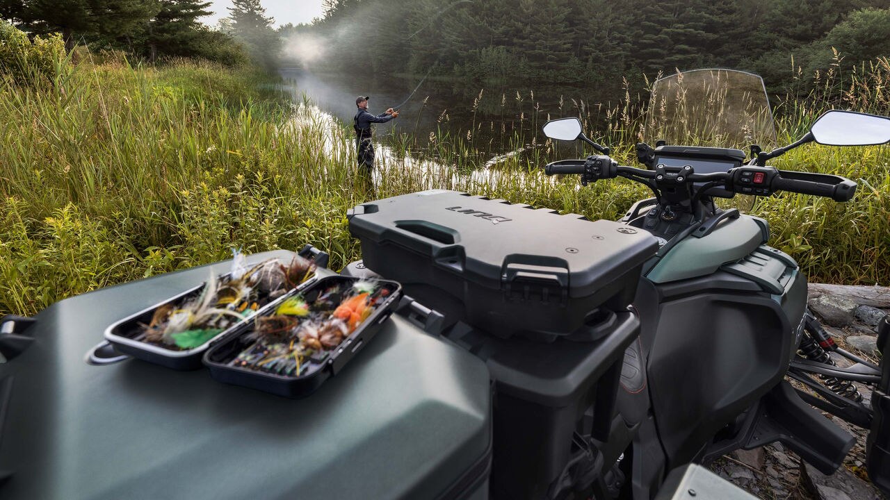 View of the all-new Can-Am Canyon Redrock 2025 and a fisherman in the background