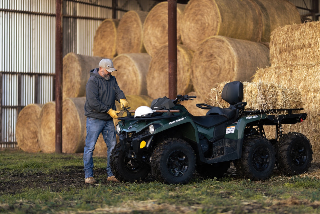 Farmer loading tools onto a Can-Am Outlander 6x6