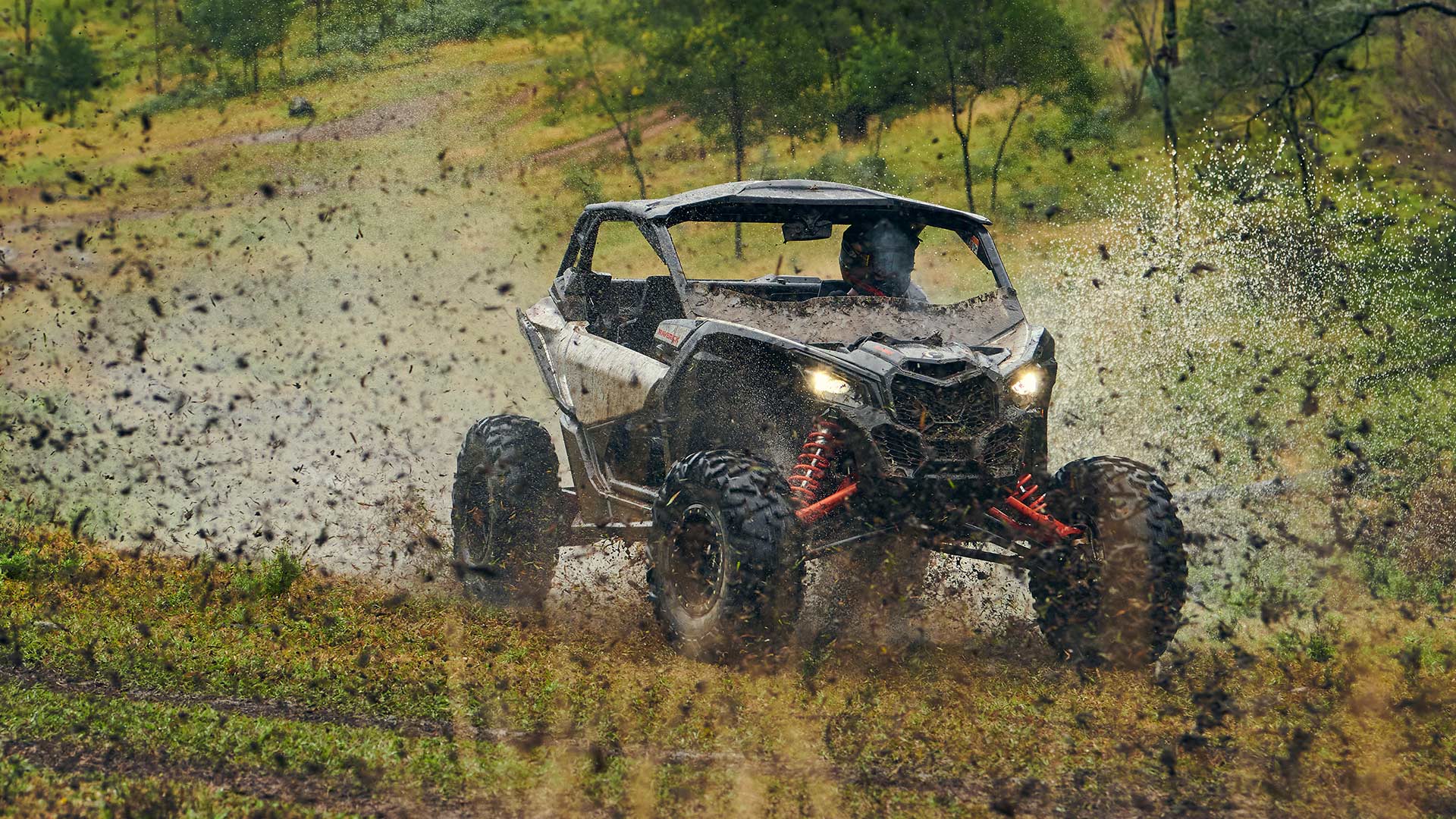 Can-Am Maverick X3 going fast in the mud
