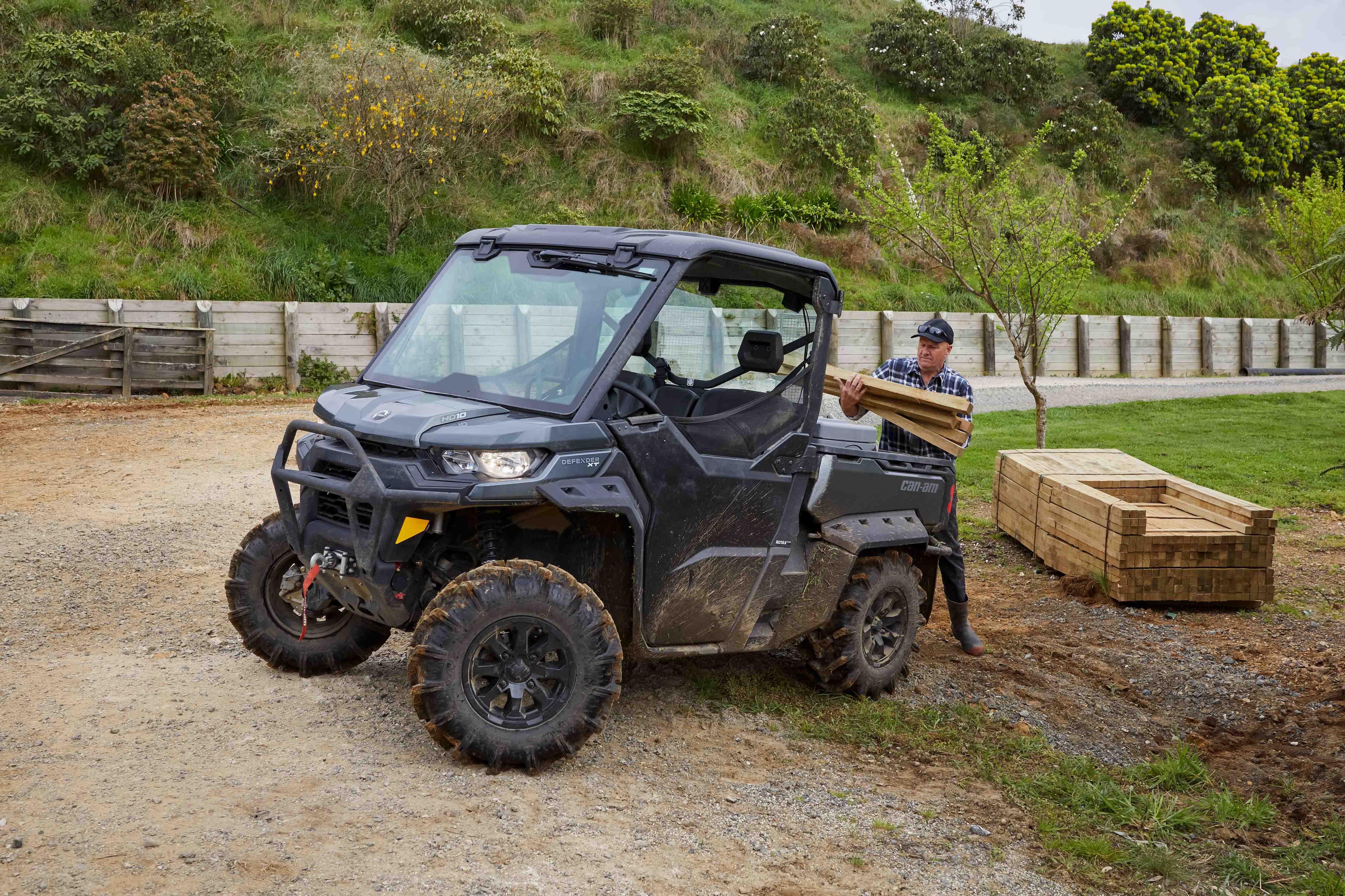 Farmer Loading his Can-Am Defender with timber