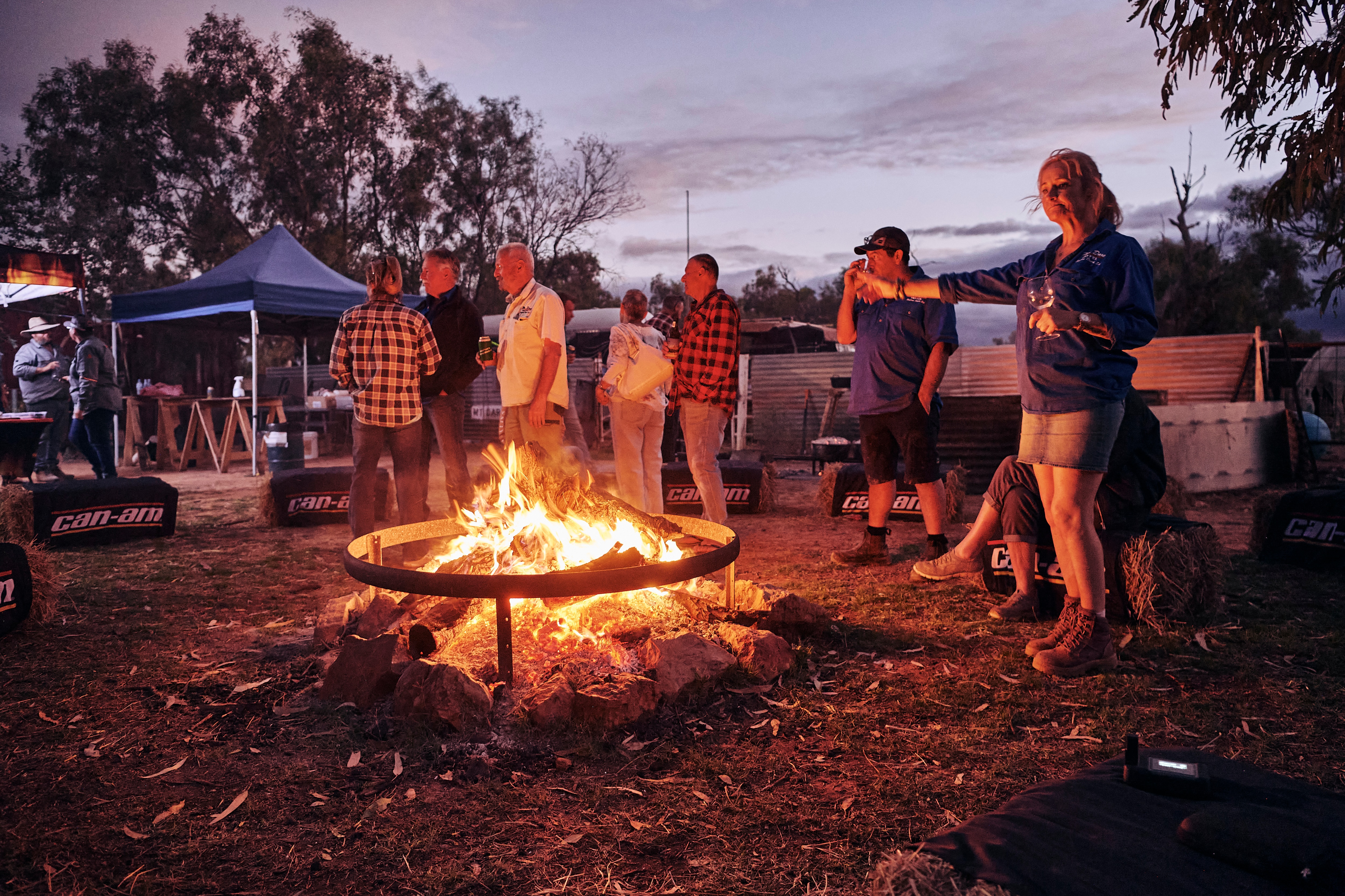 People standing around a camp fire
