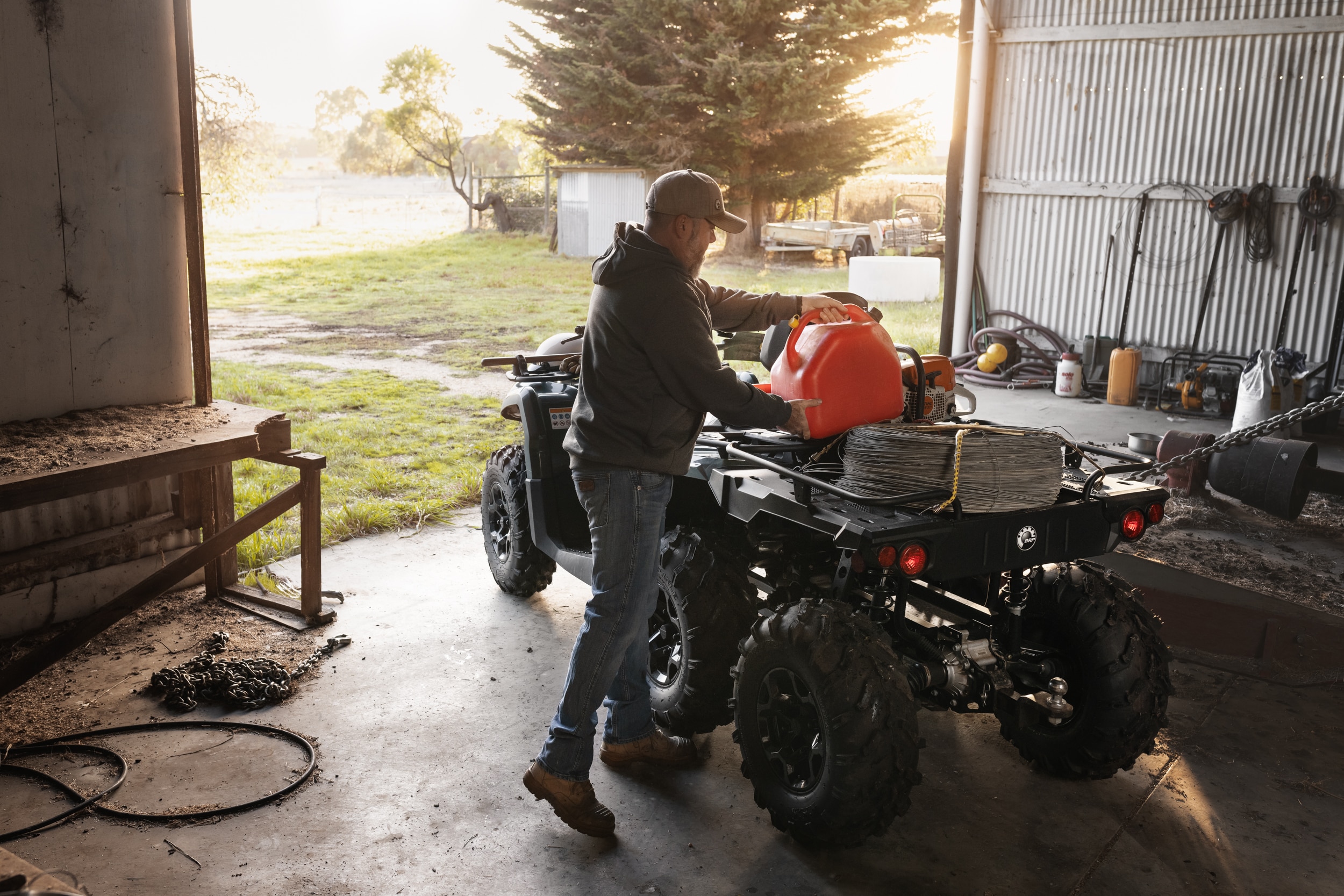 Man loading tools onto Can-Am Outlander 6x6