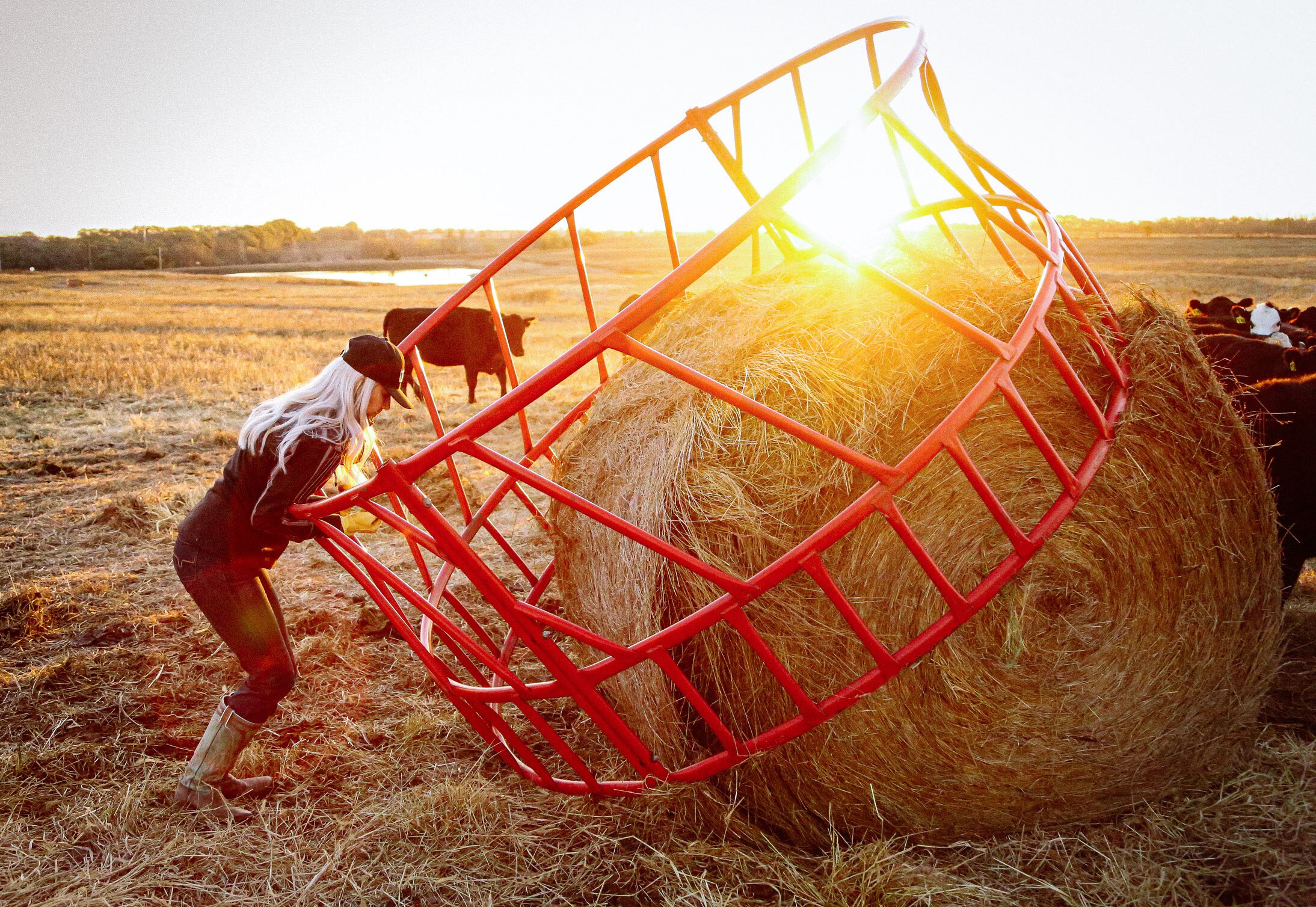 A woman working with a hay bale