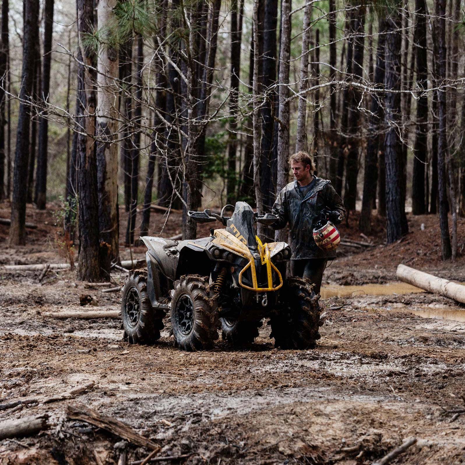 A Catalyst Gray and Neo Yellow Can-Am Renegade X MR 1000 parked beside a mud hole
