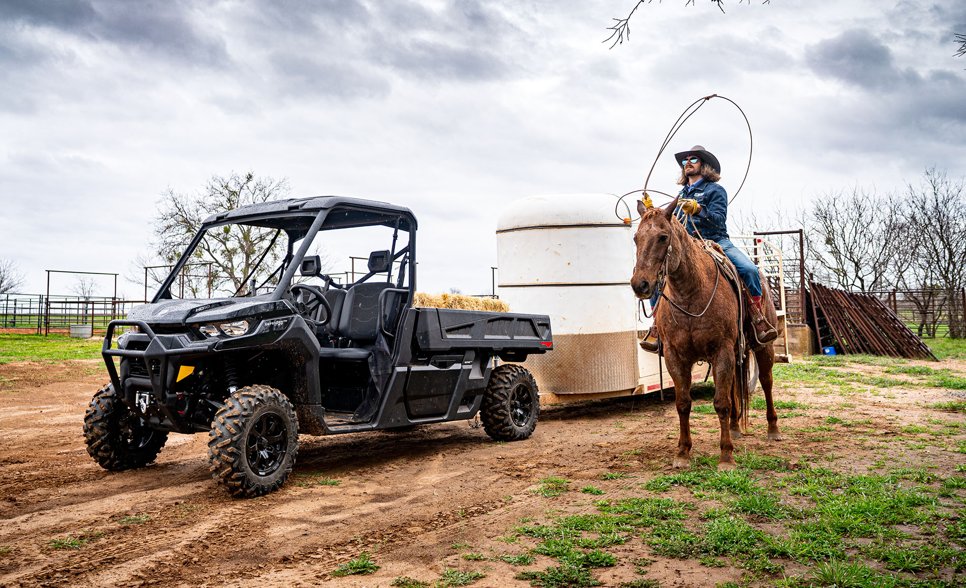 Dale Brisby on horse beside his Defender Pro