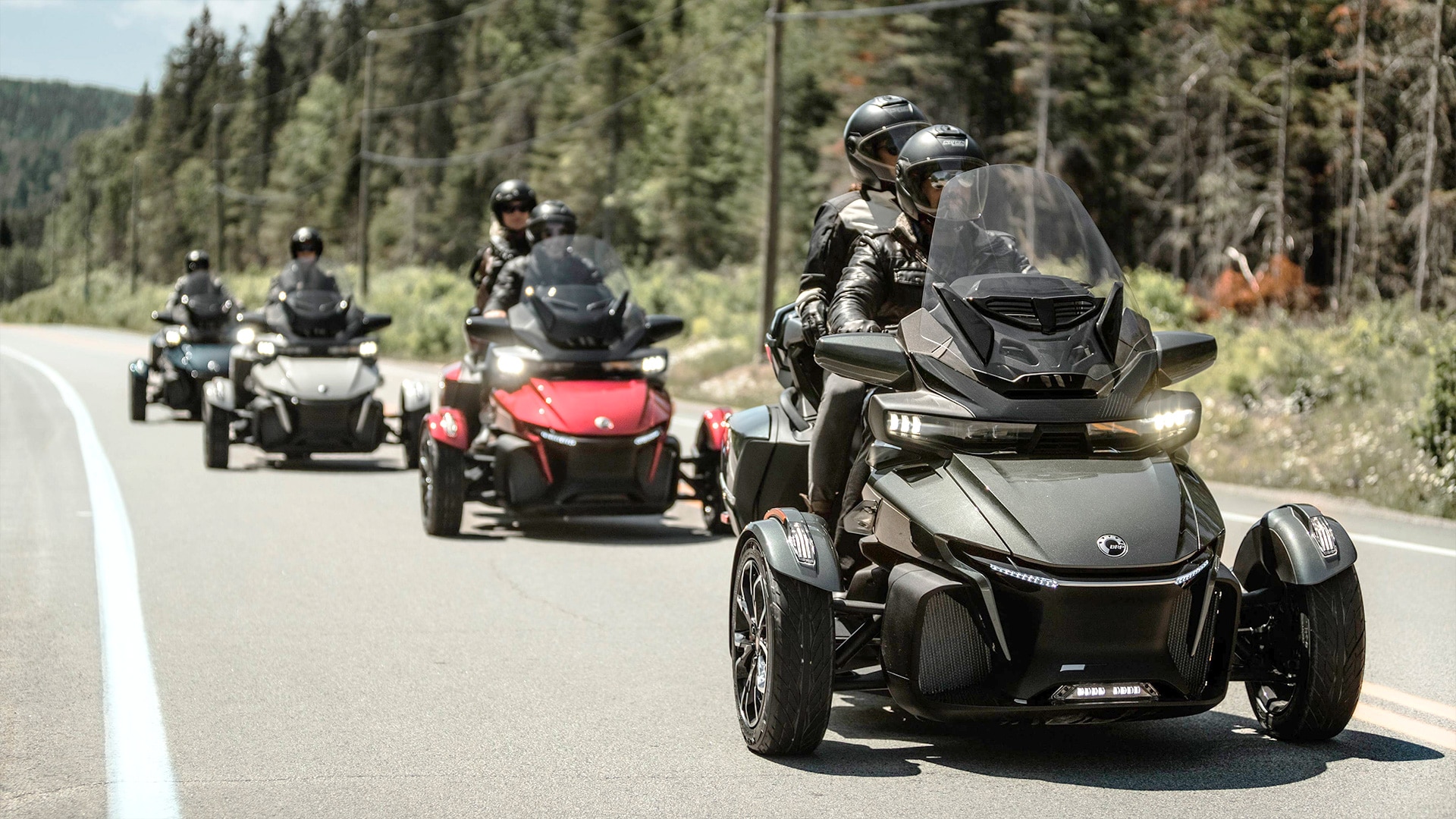 Riders with their Can-am three-wheel motorcycle