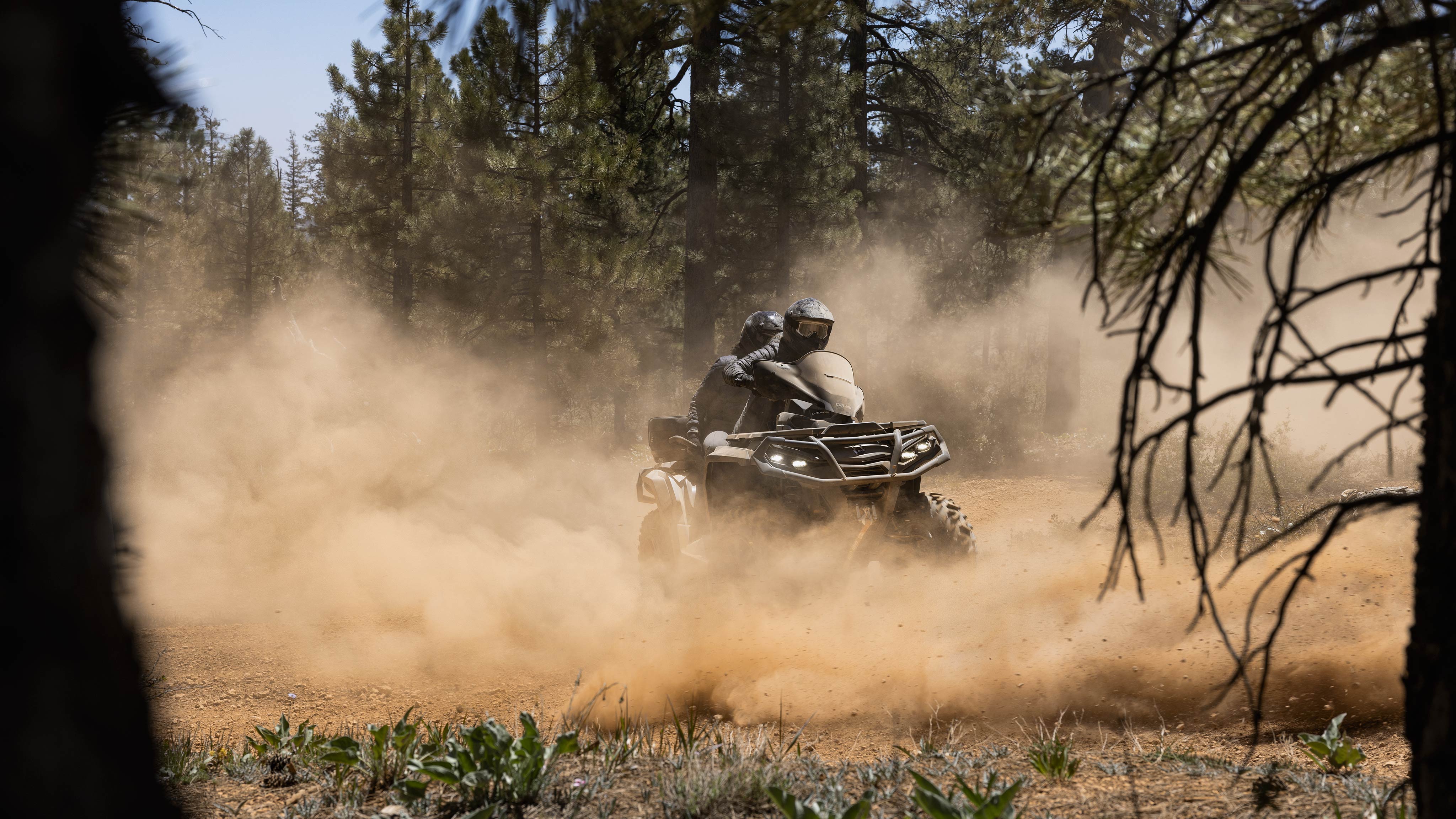 Can-Am Outlander 2022 riding on a dusty trail.