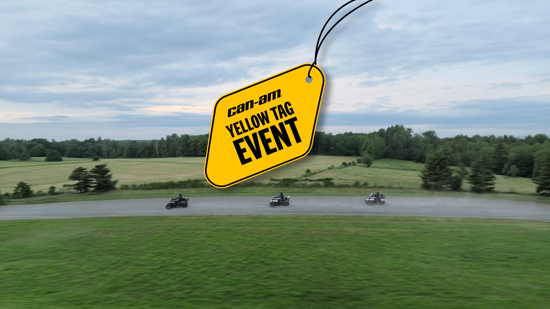 Three Can‑Am Canyon 3‑wheel vehicles lined up on an unpaved road