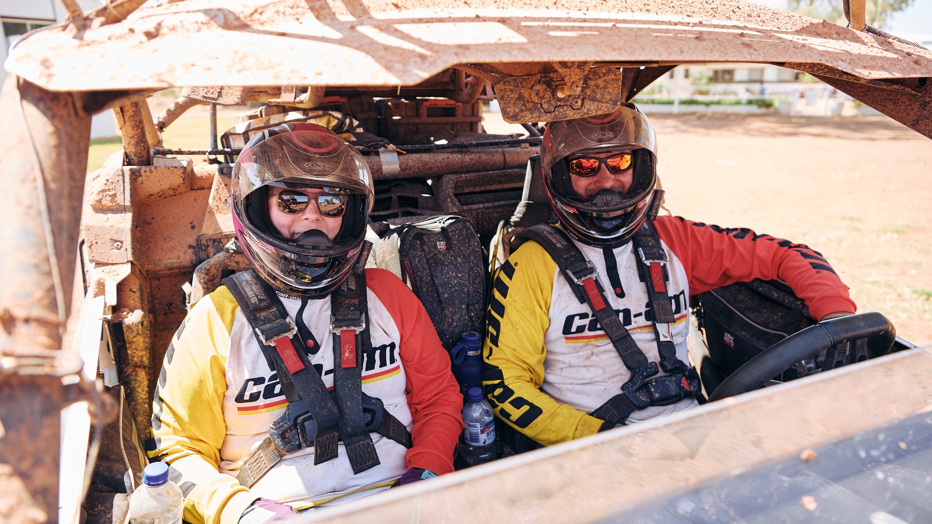 A man and a woman sitting in the front of a Maverick X3 smiling.